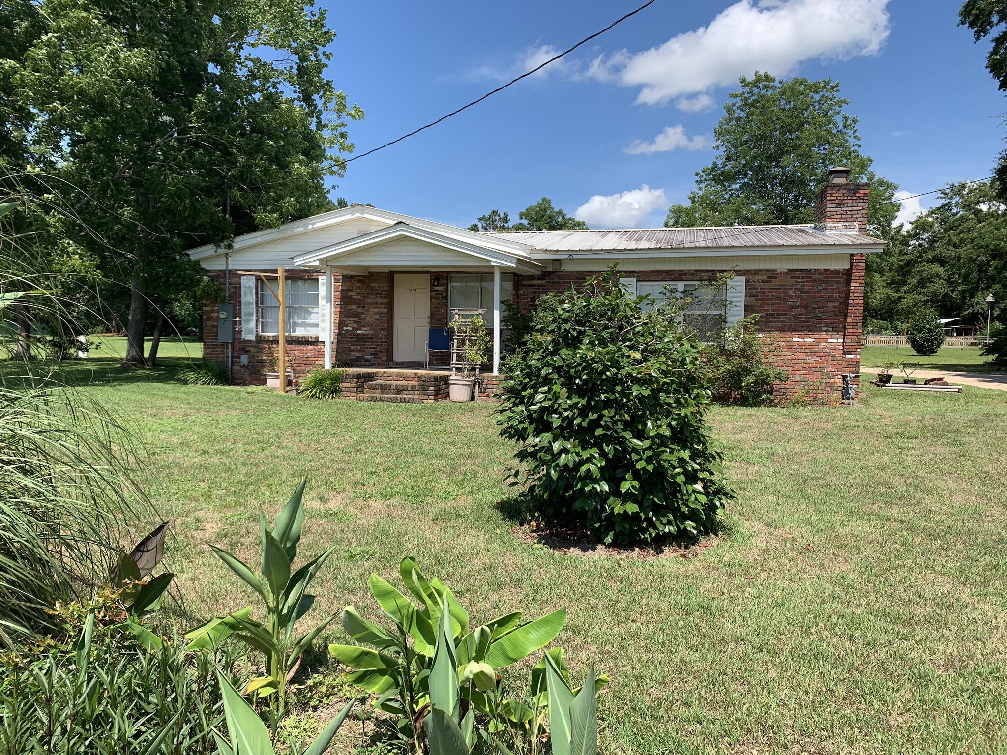 Wow! Beautiful flat 1.02 acre lot with just the right amount of open space and trees for shade. Enjoy the featured brick wall with natural gas fireplace in the huge master bedroom. The home also features a Ranii endless water heater that services the three bathrooms! 2 shops make this perfect for storage and or the handy person. Each bathroom has its own septic. Serval fruit trees coming on at this time. Also, are several large oaks on the property.