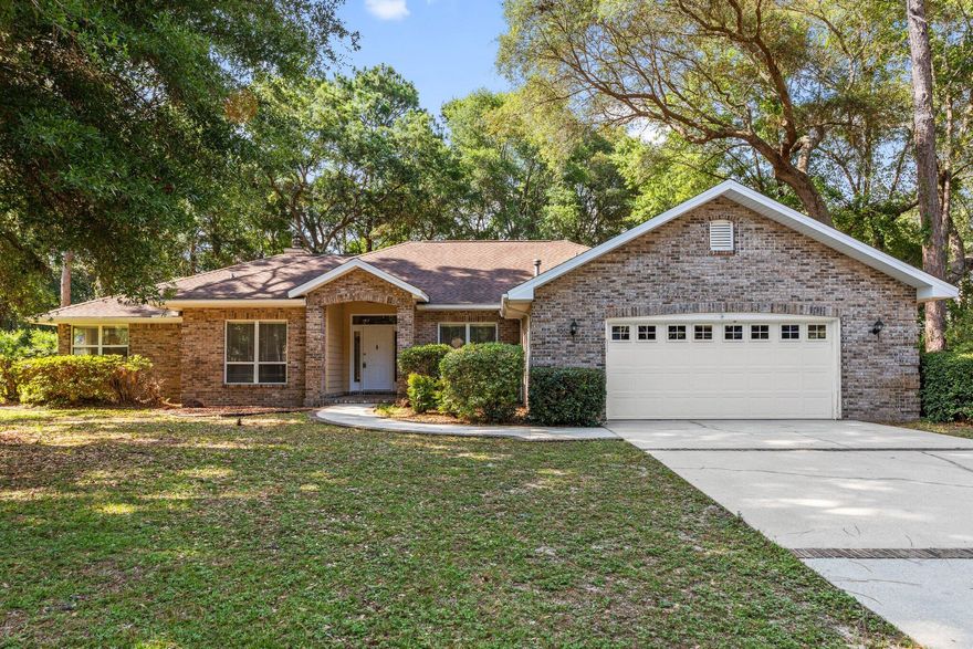 Nestled in the sought-after Rocky Bayou community, this inviting single-story brick home offers comfort, space, and timeless charm. Step through the welcoming entryway into a large formal dining room filled with natural light from a picture window. The cozy living area features vaulted ceilings and a warm fireplace with a classic wood mantle--perfect for relaxing or entertaining. The spacious eat-in kitchen is a chef's dream with upgraded maple cabinetry, stone countertops, sleek black appliances, a gas range, and built-ins for extra storage. A walk-in pantry and a butler's pantry--complete with a second refrigerator--add convenience and function. All bedrooms are carpeted and feature ceiling fans. The primary suite boasts a tray ceiling, French doors opening to the private backyard, a large walk-in closet, and a luxurious en suite bath with double vanity, soaking tub, and separate walk-in shower. The additional bedrooms are connected by a Jack-and-Jill bath, each with its own expansive vanity and a shared toilet area. A third full bathroom includes a walk-in shower and is conveniently located near the laundry room with extra storage. Enjoy the outdoors year-round from the screened-in lanai overlooking a serene, private backyard with mature trees. A two-car garage completes the home's practical layout.