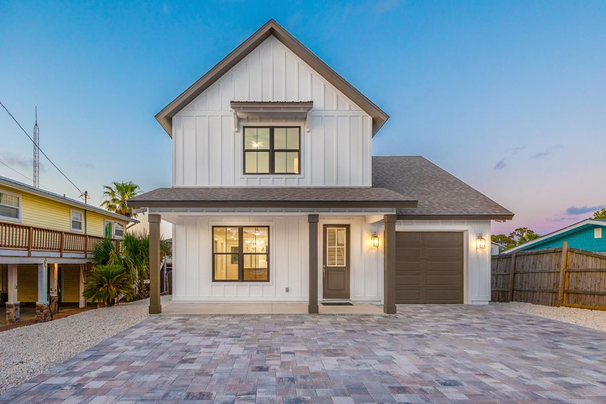 Welcome to 6424 Sunset Avenue in Panama City Beach! This brand-new, move-in ready home blends coastal charm with modern elegance, offering high-end finishes, thoughtful design, and a prime location near the beach and Grand Lagoon. Interior features include a spacious living room with inset shelving, a designer kitchen with a blue island and natural wood accents, custom white cabinetry, quartz countertops, full-height backsplash, champagne bronze fixtures, and under-cabinet lighting. The primary suite showcases a wood-paneled ceiling, shiplap accent wall, and a luxurious en-suite bathroom with a custom-tile rainfall shower and dual vanities framed by a natural wood shiplap wall. Upstairs offers a full bath with tiled tub/shower combo, a coordinating accent wall, oversized bonus room, and a insulated unfinished attic spaceideal for a future game room, theater, or additional storage. Step outside to your private Pebble Sheen plaster pool featuring an exposed aggregate finish with emerald stone accents. Built by Cox Pools with a steel-reinforced shotcrete shell (lifetime structural warranty), 10-year finish warranty, 3-year equipment warranty, and one month of pool service included. The yard is low-maintenance with pavers, gravel, and fresh landscaping. Energy-efficient sun-deflecting shingles help reduce heat absorption and keep the home cool. Located just a short walk, bike ride, or golf cart trip to the beach and boat launch. No HOA. This stunning new home is ready for you to move in and start living the coastal lifestyle!