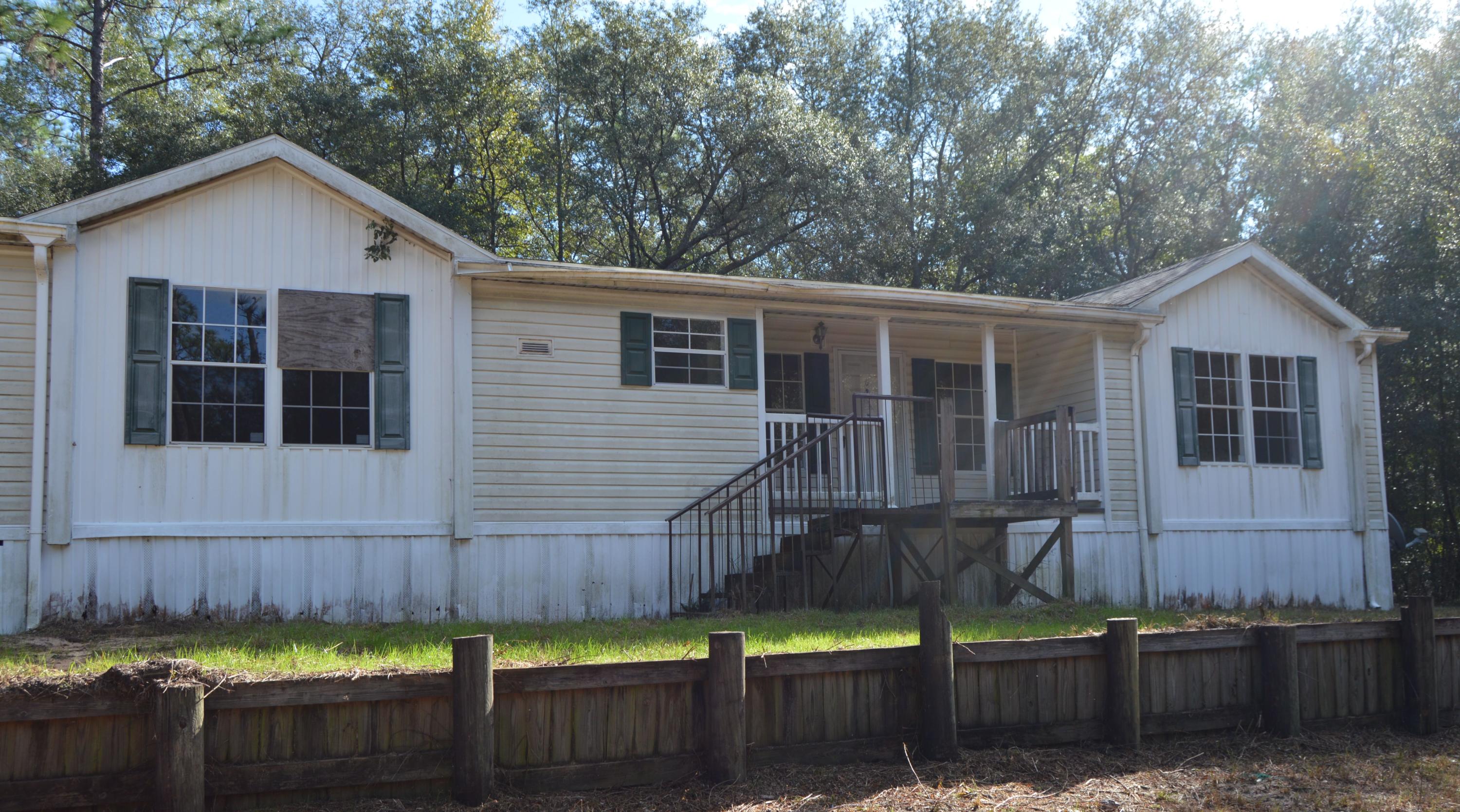 Conveniently close to Interstate 10 and the Yellow River Wildlife Management Area, this 3 bedroom/2 bath manufactured home is situated on just over 2 acres of land and boasts an abundance of privacy! It features a split bedroom floor plan with a large master bath with double vanities, separate shower and a garden tub. The open kitchen with island offers plenty of space. You even have a fireplace to cozy up to on those cold winter nights!