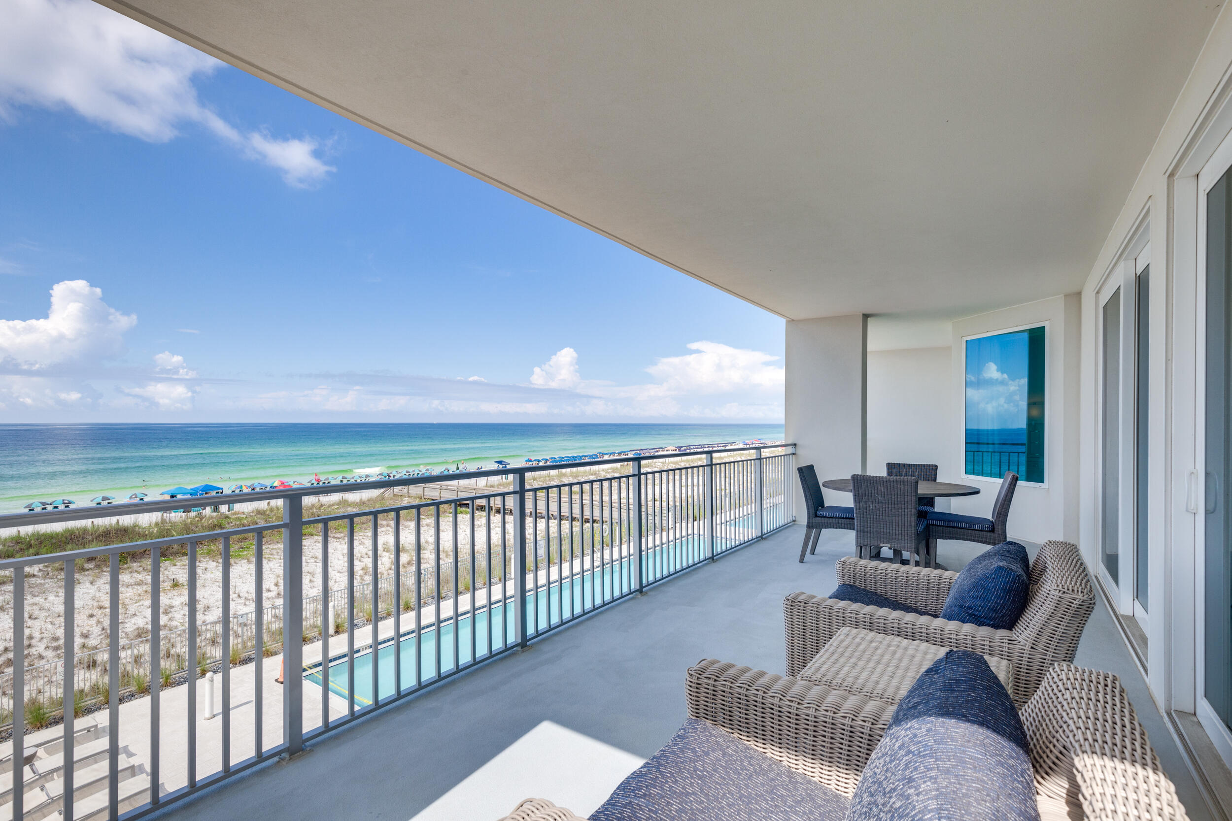 THIS IS A MUST SEE!! This floor plan is very desirable and doesn't come on the market very often. It is a 4 bedr/3 ba END unit with a HUGE balcony and ASSIGNED COVERED PARKING #117. The living and kitchen/dining area offers an open layout allowing extra sunshine and views of the Gulf of Mexico's Emerald Waters and the Snow-White Sandy Beaches. The oversized balcony, which is also accessible from the master bedroom, is like a second living area. The master suite has a walk-in closet and a big bathroom with two sinks, soaking tub, and shower. This condo has never been rented or hardly used. It is in TOP CONDITION and PROFESSIONALLY DECORATED by Sugar Beach Interiors. There was no limit to what was done. Also has custom drapes and all accessories done by the same decorator.
