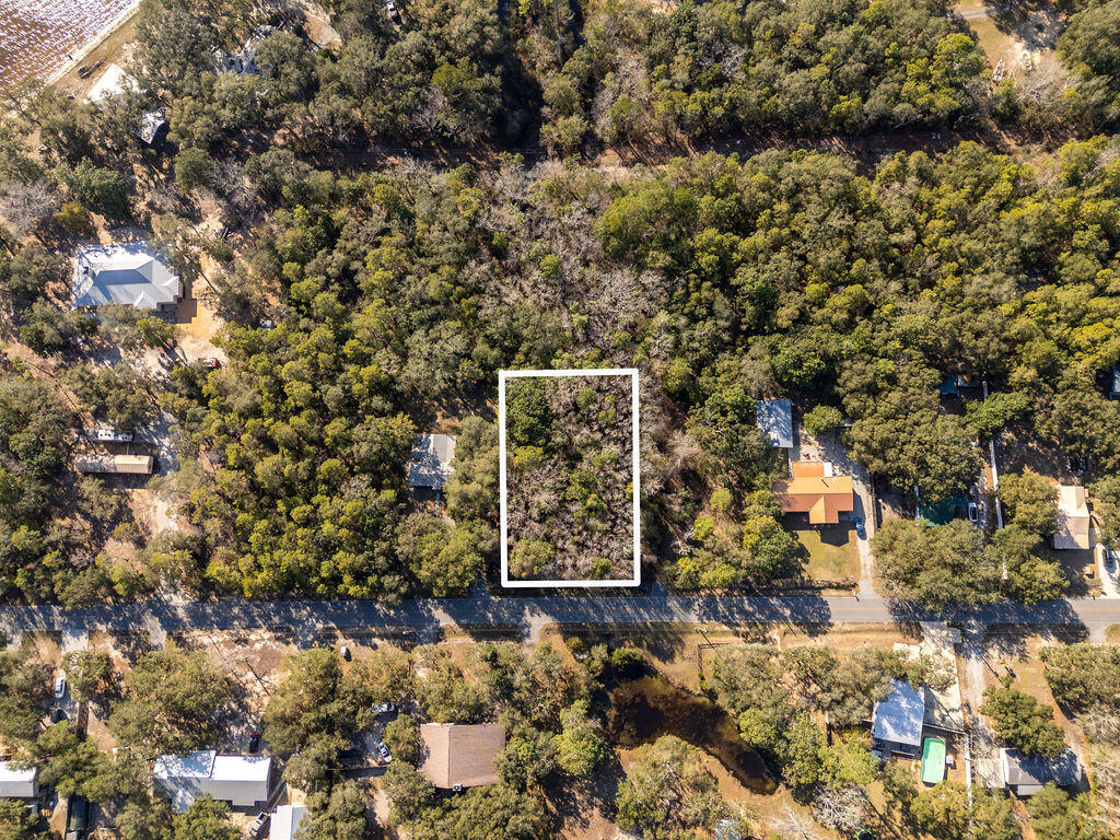 Discover the perfect spot to build your dream home! This level, nearly half-acre lot is nestled between Freeport and Niceville, offering both convenience and a peaceful setting. Enjoy the beautiful view of the bay, and the coastal breeze as you drive down Marsh Dr. to your new home. No homeowners association (HOA) restrictions, offering a blank palette . Whether you're looking to create a private retreat or an investment property, this location provides an excellent opportunity.Don't miss this chance to own a piece of the Florida Gulf Coast!