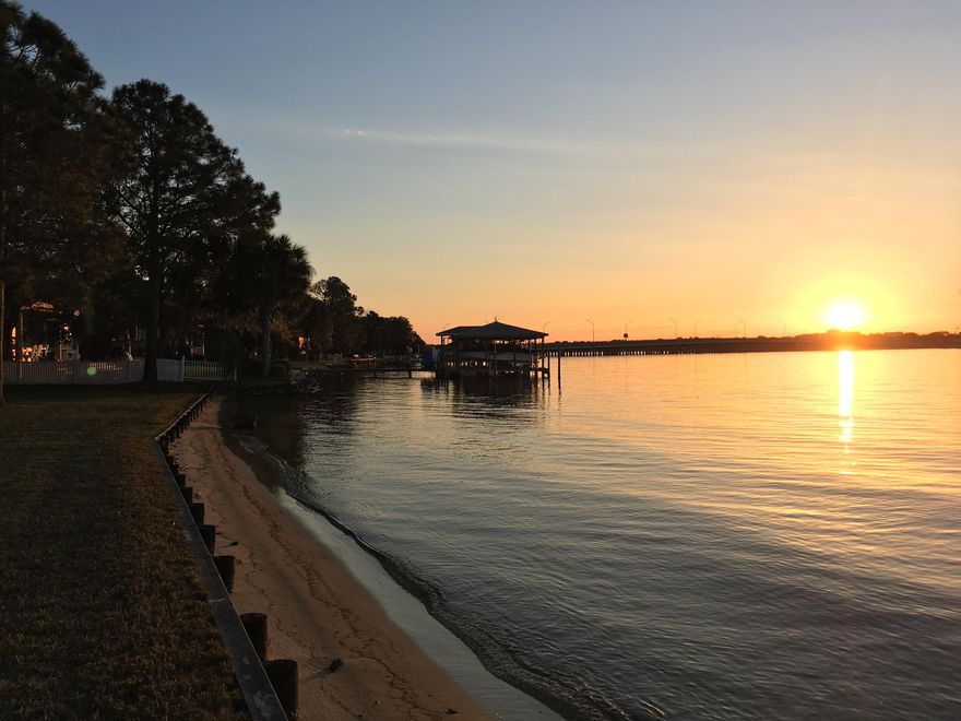 Waterfront lifestyle at it's finest! Included a 30'deeded boat slip. Western sunset views over Garnier's Bayou set the tone for this incredible 3 bedroom, 2.5 bathroom townhouse straight out of the pages of Coastal Living magazine! Panoramic views of the bayou from almost every room as the current owners attention to detail and eye for renovation set this property up for ultimate enjoyment. The foyer greets with custom travertine flooring throughout the open concept first floor. The kitchen is well equipped with stainless appliances (fridge negotiable), farm-style under mount sink, designer cabinets, Granite counters and breakfast bar. Large great room with plenty of space for family and guests. Custom built-in's allow for storage and display of your collectables and TV entertainme
