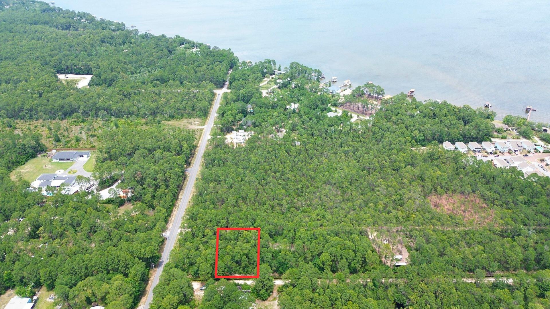 Large wooded lot that would be an ideal site for a primary residence, beach vacation home, or an income producing property. NO HOA, no build out time. Kellogg Bayside Park is within close proximity and Cessna Landing boat launch is less than 3 miles. Located in Flood Zone AE. Buyer to do their own due diligence.