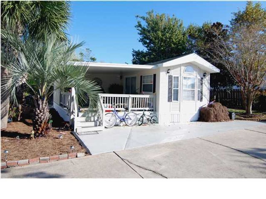 Located just 2 blocks to the beach, Bradley Park is a 14 lot RV type part. This manufactured home is located on one of the largest lots (40 x 70) and has been recently updated. Updates include wood flooring, granite countertops, & additional bedroom with full bath. This home is being sold furnished with washer, dryer, refrigerator w/ice & water on door, stove w/ smooth cooktop, microwave, dishwasher, & flat screen TVs. The Dining area has built-in China Cabinet. The Living area has a built-in desk & hutch and can be closed off from the living area for privacy. There is a large covered porch, music speakers, plus a fenced in back yard with separate yard building behind the home. Each owner has a 1/14th ownership of the common area and the quarterly assessments of $165.00 includes