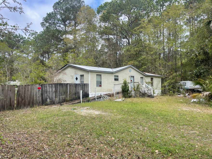 Opportunity awaits at 93 Laird Dr in Freeport! Situated on a generous .42 acre homesite, this property offers an opportunity for anyone looking for their next project. The home is being sold AS IS and is in need of repairs, making it ideal for renovation or potential replacement. There is a Detached Garage with Carport over cement slab and also a stand alone Shed.With Freeport's expanding amenities including the Choctawhatchee Bay, and the beautiful beaches of the Emerald Coast, this property holds strong potential for the right buyer willing to bring it back to life. The front yard has a privacy fence on the left. The back yard has a chain link fence. HVAC was working in 2025. Electricity has been terminated and will not be turned on for inspections. Flooring and Bathrooms are in need of updating. There is trash/items of no value around the home and two RVs both  considered to have $0 value. Bonus!: The adjoining Lot (wooded) to the West is also available for purchase. See separate listing under land.
THIS SALE IS AS IS; No Repairs. No Clean Up. The boat, boat trailer and truck do not convey.
THIS IS A CASH-ONLY SALE; no financing options available. Showings by appointment ONLY. 
Seller has never occupied the property and has no disclosures or knowledge of its past or current condition. Seller is making no claims or warranties of such property. It is the sole responsibility of the buyer to inspect the property to determine its condition.  