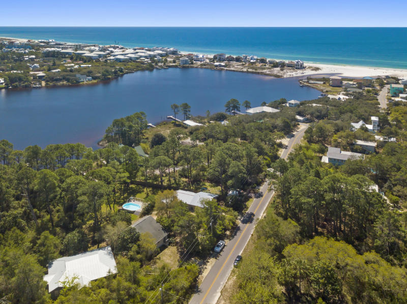 South of Hwy 30A in seagrove area. This lot shares a lakefront lot for dock ion eastern lake. Dock allows you to keep a pontoon boat for cruising and also great for kayaking or Yolo boarding. Lot offers direct lake access and home would have forever views of Eastern lake. Large lot with additional land available. It will shared ownership of lake lot with home next door. Just a short stroll to beach .