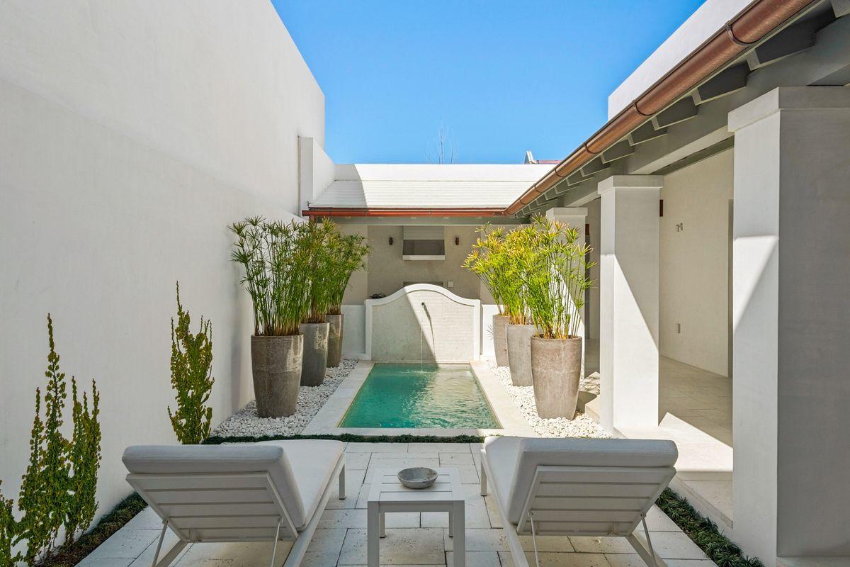 Classic design and clean lines exude from this Gary Justiss designed home, located on iconic North Charles Street. Featuring a generous courtyard complete with a pool, open loggias, and a summer kitchen, this home is perfect for outdoor entertaining. As you enter the home from the courtyard, you will immediately take note of the interior design of Betsy Brown, whose style, as featured in House Beautiful ''teases classical and modern elements into elegant harmony.'' Unique details of the home include full Venetian Plaster walls and ceilings, Carrara marble throughout the kitchen and bathrooms, a custom Venetian Plaster range hood, and Wolf and Sub Zero appliances.