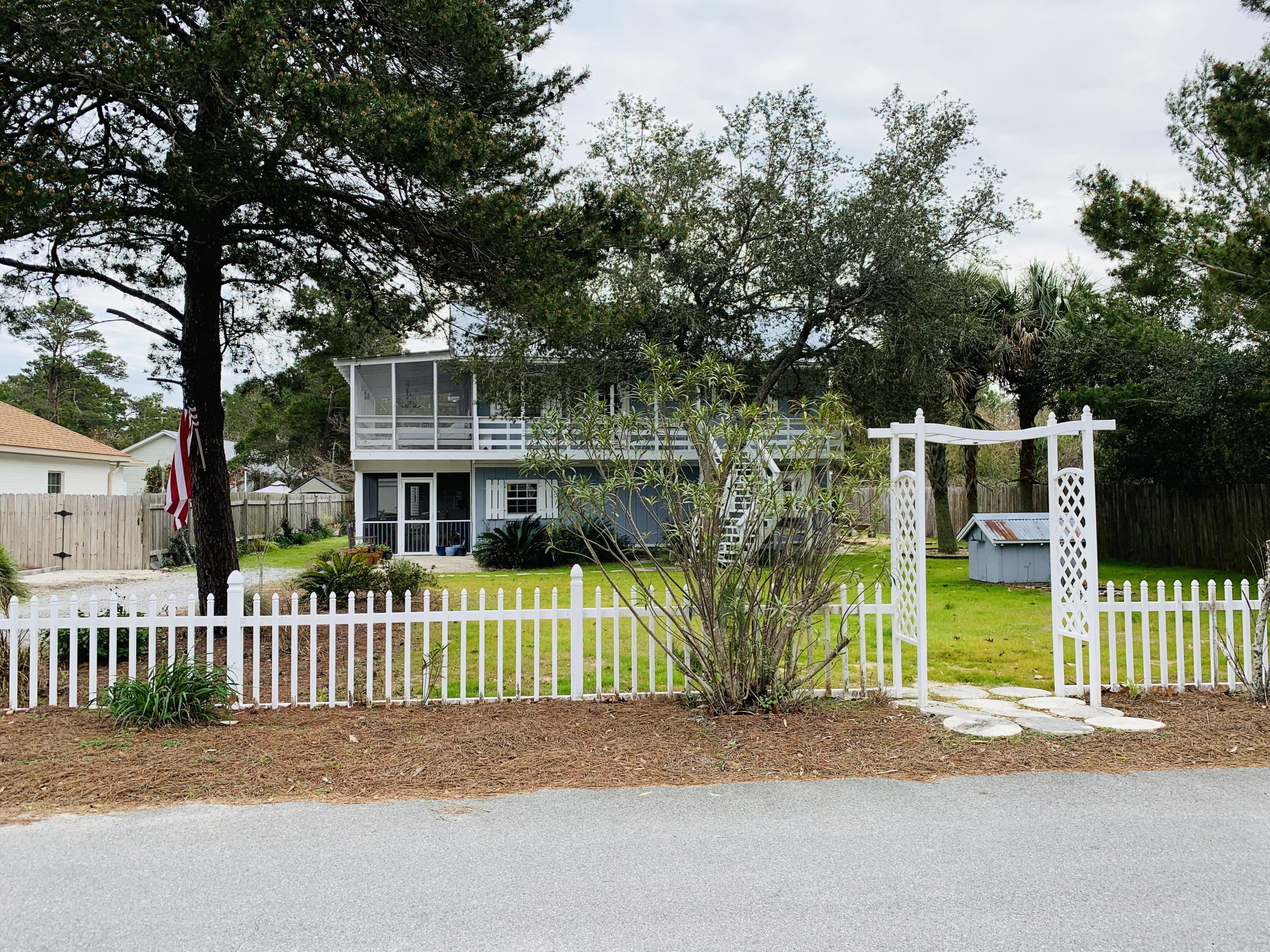 Fixer-upper beach house on 30A and priced as such. Must be Cash or Remodel Loan due to woodrot at siding. Location, Location, Location. Heck of a find for a Handy person. 2 screened porches & 2 living areas! The downstairs can easily be converted to a mother-in-law/lock out unit/Duplex! Walk out to the screened porch w/ hanging bed for relaxing & morning coffee or sunset beverage. This subdivision is one of the few w/ large lots & room for a pool. Just North of Hwy 30A near bike/hiking trails, restaurants, Gulf Place concerts & shops yet away from the hustle & bustle. NO ASSOCIATION FEES yet walk/golf cart to gorgeous white sand & turquoise waters of the Gulf. Can do $40k whole house/$20k per side. Can park a boat/RV. Flood ins not Req. Don't wait! Getting Repair Quotes.