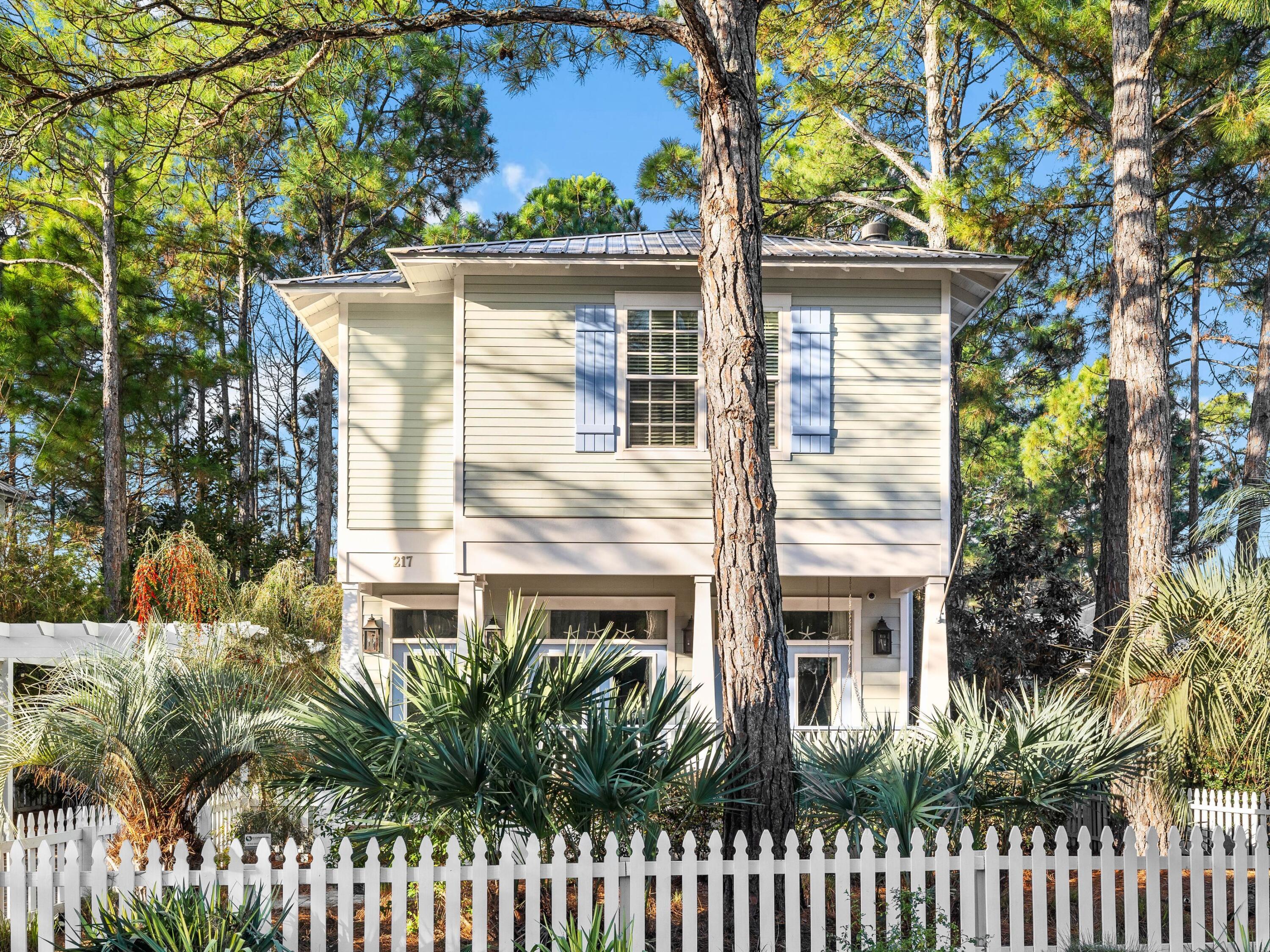 Welcome to this one-of-a-kind beach retreat, where character and charm blend seamlessly with modern luxury. Tucked away on one of the best lots in Cassine Village, this home overlooks a peaceful nature pond and is surrounded by lush trees and vibrant foliage, creating a serene oasis. The private, brick-paved driveway leads you to a whimsical gate that opens to a shaded path lined with pine needles, inviting you inside. The inviting front porch, complete with a swing seat, epitomizes laid-back coastal living and is the perfect spot for relaxing and savoring the breeze. Inside, the home exudes warmth with oak flooring that gives the space a rich patina. The airy living room, with its soaring 10-foot ceilings, creates a spacious and welcoming atmosphere ideal for cozying up by the fireplace or gathering with friends and family.

The chef's kitchen is a true showstopper, with high-end Jess & Gray rustic lighting, full-height cabinets, stainless steel appliances, and stunning granite countertops. The stylish tile backsplash and custom-glazed shelving add a luxurious touch, while the raised countertop bar invites conversation over cocktails and canap??s. A large pantry, half bath, and a private storage room tucked behind the pantry offer plenty of space and convenience for everyday living.

French double doors open to the screened porch, where you'll enjoy a full-sized outdoor living area with oak accents and taller-than-usual ceilings that provide a sense of openness and space. The perfect place to unwind, watch the wildlife, and enjoy the gentle sounds of nature. An outdoor shower is nearby to rinse off sandy feet after a day at the beach.

Upstairs, the master bedroom is an elegant retreat, featuring crown molding, custom lighting, and a private en-suite bath with a walk-in closet. The master also opens to a private, screened porch where you can step outside and soak in the beauty of the nature-filled surroundings. An additional guest bedroom and bunk room share a second full bathroom, which features a heated bidet for added luxury and comfort.

Outside, the home's backyard extends to the nature path, winding through lush cypress groves and leading directly to the state park. For pool lovers, this community is the one for you! With two community pools just across the street, you'll be able to enjoy the ultimate relaxation. There's also room to add your own pool in the backyard if you prefer a private oasis.

The property features a tool shed attached to the home with double doors for convenient outdoor storage, along with a separate shed that is equipped with electricity. Whether you're looking for space for hobbies, tools, or extra storage, this home offers it all. With a highly desirable location, ample space, and thoughtful amenities, this home is truly a rarity, offering everything you need for relaxation and comfort.

Cassine Village offers excellent community amenities, including tennis and pickleball courts, making it a popular choice for vacationers. The powder-soft white sands of Seagrove Beach are just a two-minute stroll away, completing this dream beach cottage experience.