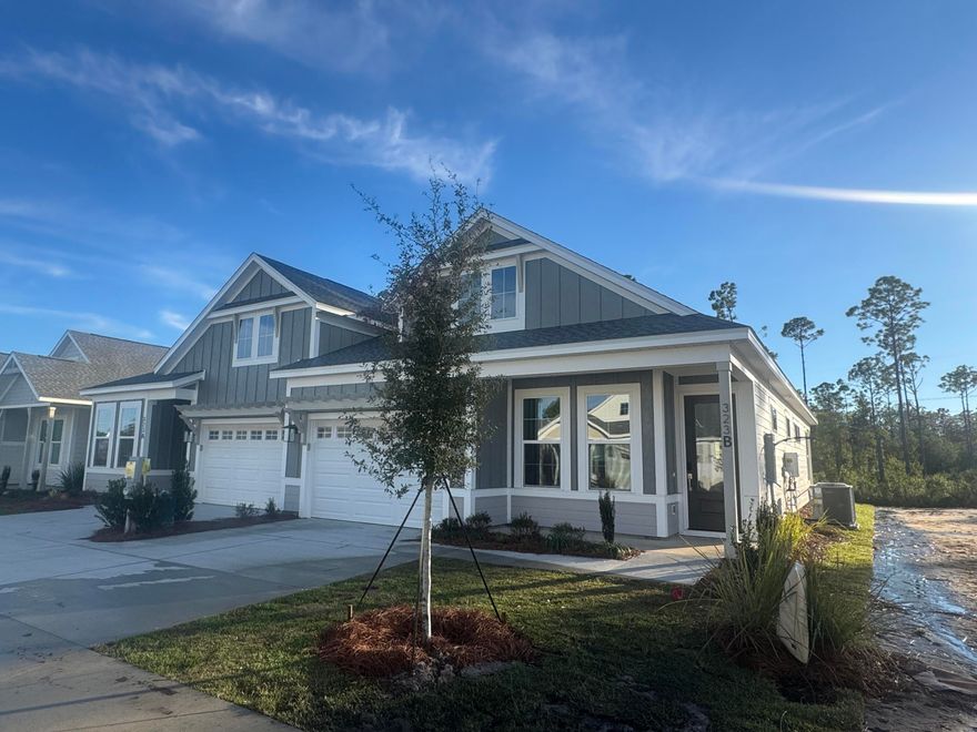 ** Seller closing cost incentive for this Market Home** This thoughtfully crafted 2-bedroom, 2-bathroom paired patio villa with 1,418 square feet and a 1.5-car garage offers easy, single-level living with modern finishes and a bright, open layout. The LUCAS floor plan by Fischer Homes welcomes you from the foyer into the connected kitchen, dining, and family room, all opening to a covered rear patio with peaceful wooded views.The upgraded kitchen is appointed with quartz countertops, under-cabinet lighting, a farmhouse sink, soft-close cabinetry, a beautiful glazed pearl ceramic tile backsplash, and a pantry for added storage. An enhanced stainless steel appliance package includes a 30inch gas 5-burner cooktop, vented canopy hood, and a built-in 30inch microwave/oven combination.

The owner's suite features a generous bedroom, an oversized walk-in closet, and a private bath with a tiled walk-in shower with frameless glass doors, quartz vanity, and raised-height cabinetry. A second bedroom and full bath near the front of the home offer versatility for guests or an office setup.

Additional interior upgrades include 10' ceilings, 8' doors, luxury vinyl plank flooring, a SmartCode touchscreen entry, and an installed Smart Home package for added convenience. Energy-conscious construction features impact-rated windows, LED lighting, and a tankless gas water heater. A family foyer/drop zone and inviting front porch complete the home's practical layout.

Estimated completion: December 2025.
Designer selections can be viewed in the Documents section.

Residents enjoy low-maintenance living with HOA-covered lawn care and exterior upkeep, along with access to the exceptional Watersound Origins amenities.
