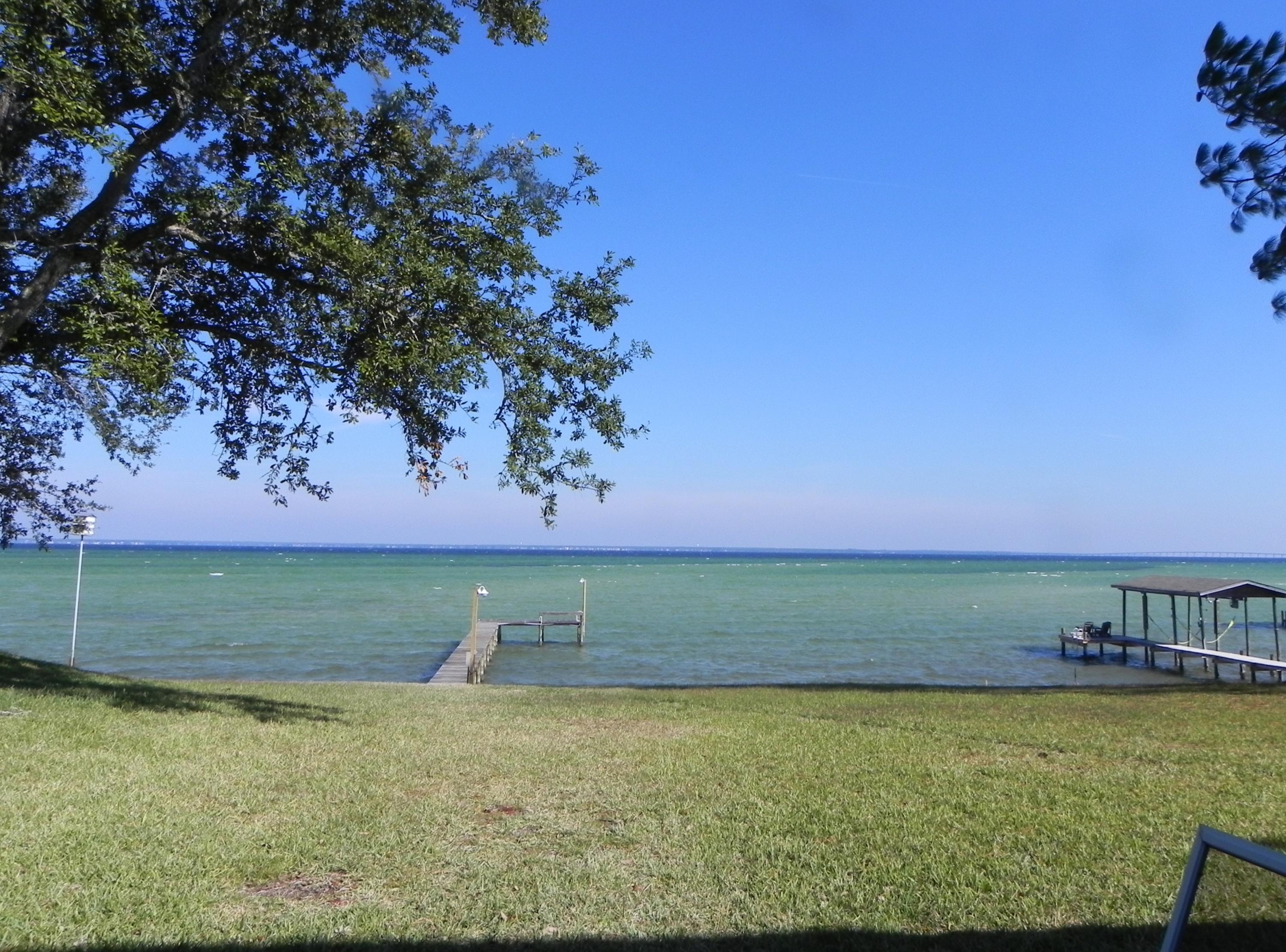 Superbly Remodeled Executive home, 100 feet on the Bay just under an acre with dock, boatlift and seawall in the heart of Destin! Over $130,000 in extensive renovations has turned this into a one of kind, must see home designed for enjoying every aspect of the beauty and serenity of the Bay and Inter-coastal Waterway. No detail was left undone, to include kitchen and baths, fogged windows, flooring, textured ceilings, hot tub with screened in porch, painting, landscaping and so, so much more. There's a huge laundry room and 2 car garage and additional parking for entertaining friends and family. All that's missing is you. Schedule your private tour today and start living the waterfront, Destin lifestyle you've always dreamed of and so deserve!