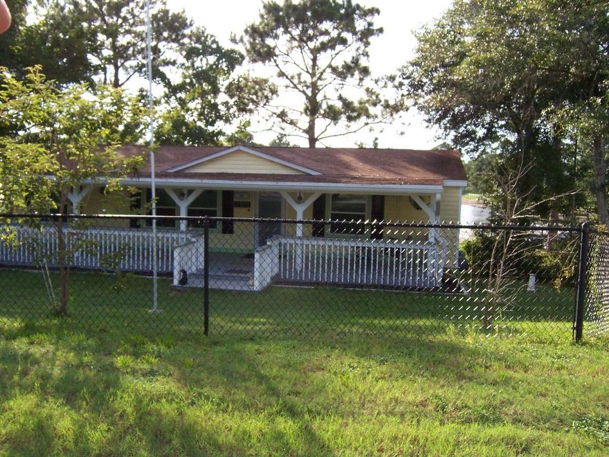 Amazing waterfront home on Juniper Lake! Doublewide manufactured home with upgraded double hung windows new paint and laminate floors, plenty of closet space, separate enclosed Florida room, large waterview den that leads out to a balcony overlooking the lake. Kitchen features a dual fuel gas stove/electric oven range with stainless hood, Huge cover front porch with fans and porch swing, new storm door, nice dock with dock-house, picture perfect yard, detached carport, chain-link fenced front yard.  Beautiful views of the lake. Paved road and quiet neighborhood.