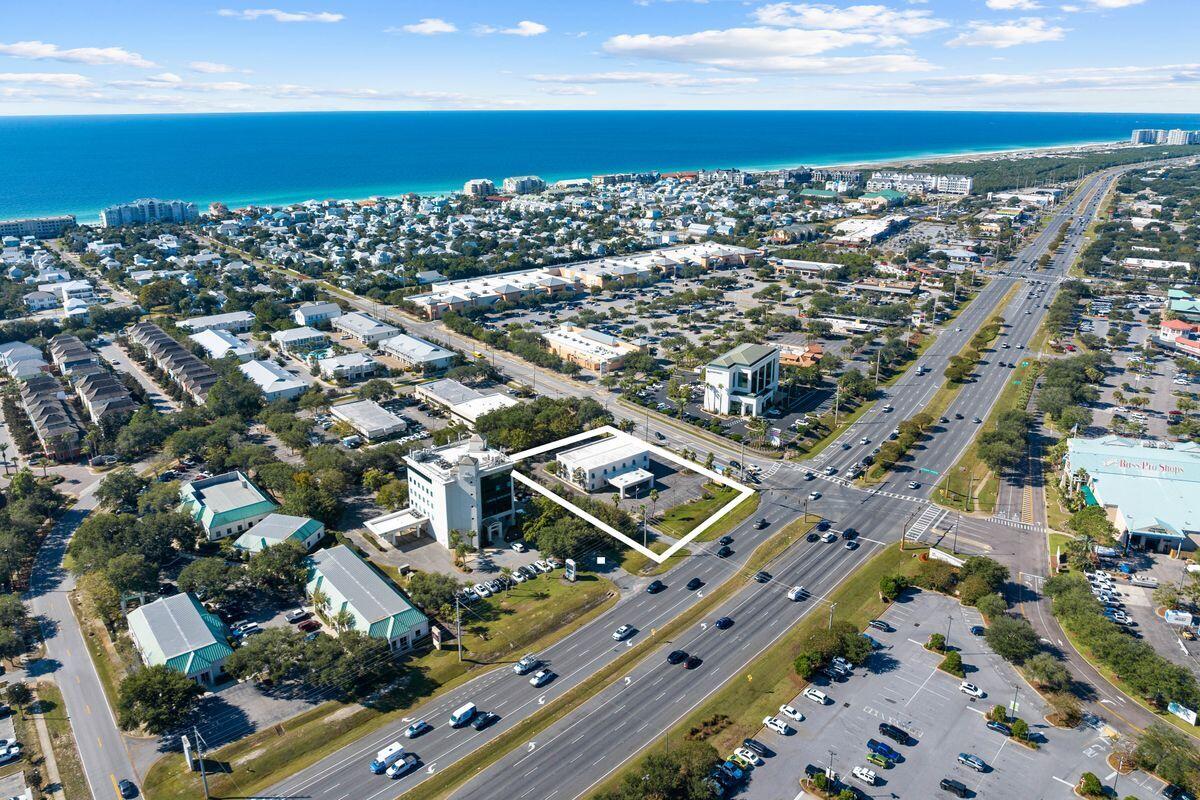 Welcome to a prime commercial opportunity in the heart of Destin. This expansive office building, once a thriving real estate and rental office, now beckons to investors and business owners alike. With a strategic location at the corner of U.S. Highway 98 and Crystal Beach Drive, it boasts an impressive 188 feet of frontage on the bustling Emerald Coast Parkway. Spanning over a 1.06 acre lot, this two-story, low-rise gem offers a multitude of possibilities. On the first and second levels, you'll find a welcoming front desk, along with break rooms, bathrooms and multiple private offices to accommodate your business needs. Outside, ample parking awaits your clients and team, ensuring easy access. This central location places you just minutes away from the Mid-Bay Bridge, a plethora of shopping and dining options, the Destin private airport and more. The possibilities are vast for this prime property and location.