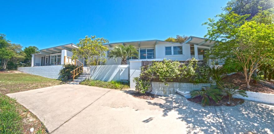 This 1.3 acre site, sits high atop the dunes with an elevation and setting you have to see to believe! This spectacular and unique home is the only one available in the private and gated enclave of Four Mile Village. A contemporary, classic style home designed by a student of Walter Gropius, Harvard Architecture Chairman. This sprawling one story home offers expansive views from both sides, spanning the Gulf of Mexico to the south and Fuller Lake, a pristine 60 acre coastal dune lake to the north. A private dock is avail to enjoy lake activities. The home offers a private setting with 3 bedrooms and 3 baths, perfect for family with two spacious living areas and kitchens. A detached garage and storage area are tucked among the beautiful oak trees. Four Mile offers