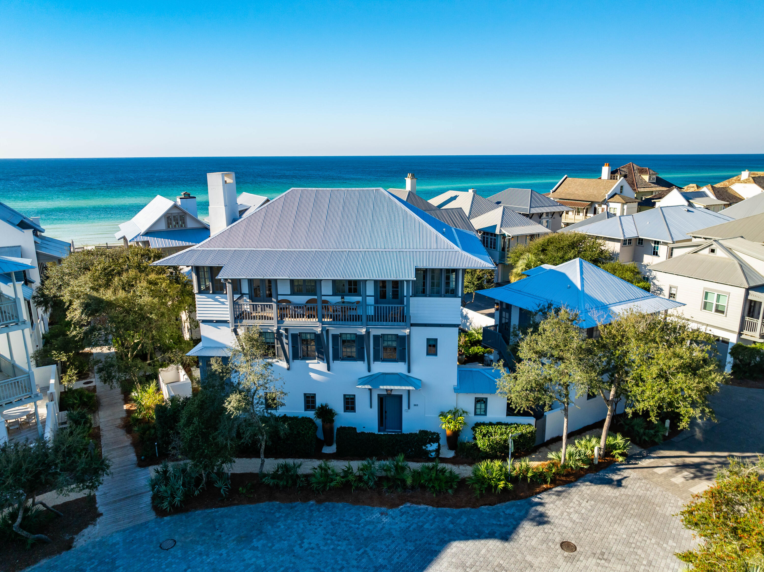 Perfectly positioned on one of the largest lots (5,300 s.f.) in Rosemary Beach, this second row, 4,345 s.f. idyllic coastal retreat, with awesome GULF VIEWS, is located adjacent to walkover A which is the wheelchair and stroller accessible access to the sandy white beaches and emerald-green waters.  Directly across Rosemary Avenue is Rosemary Children's Playground and Park that is shaded with sand flooring so the kids can run and play barefooted when taking a break from the beach making untold memories with their friends, siblings, parents, and grandparents.  Designed by Eric Watson with curated selections from Tracery Interiors create a unique continuity throughout the home which showcases a mix of natural stone and hardwood floorings, venetian plaster and pecky cypress walls, exposed beam ceilings,  revived with new rugs, chairs, couches, art and refreshed landscaping.  Topped off with a new metal roof and gutters.   

This home's unique beauty is expressed through the rich color palate, construction materials and masterful architectural details.  The primary characteristic is the elevated masonry base which allows porches and outdoor spaces to catch cool ocean breezes.  Details like shuttered windows and doorways, lofty, very high ceilings, steep roof, to shed rainwater and large porches that act as another living space in the home were added to the design making the end result a very uniquely styled home that elevate the coastal aesthetic with familiar and natural materials.  

The full sized Elevator services all three floors.  State of the art electronics including the homes' lighting, climate and security controlled by Savant system.  Two private Guest ensuites sit on opposite wings of the first level with direct access to the resort inspired courtyard oasis with a sparkling salt water pool with sun shelf, water feature and summer kitchen with Lynx grill, ice maker, refrigerator, marble countertops, outdoor shower(s).  Positioned between the two ensuites is the Media lounge for gaming, movies, and quiet time that includes a wet bar.  

The second level Primary suite is adorned with luxurious fabrics, venetian plaster walls, a limestone fireplace, and a lavish ensuite bath with double rail head shower with free-standing tub.  French doors open to the balcony overlooking the pool.  A picturesque bunk room complete with a separate media room and gamer's paradise complete the second level.  

As you enter the living area of the third level you are met with Gulf Views from every corner of the living and kitchen areas that lead out to the full length balcony where you can enjoy ocean views, stunning sunsets, and smell, hear, and feel the wind and ocean.  It doesn't get any better than this in Rosemary Beach!  Anointed with new furnishings, rugs, and art the limestone fireplace is centered for your enjoyment and you'll enjoy the open living space with high beamed ceilings, a customed tufted banquette, and first class kitchen with marble counters, 6-burner Wolf stove, double Thermador ovens, a new Wolf  refrigerator and new Bosch dishwasher.  Sweet!

Attention to detail and functionality was continued to the carriage house that boast of Gulf Views from the porch, separate living area with a Full kitchen, modern cabinetry, hardwood flooring, and private bedroom.

Rental income has been as high as $500K annually with 70+ exemplary reviews.   
