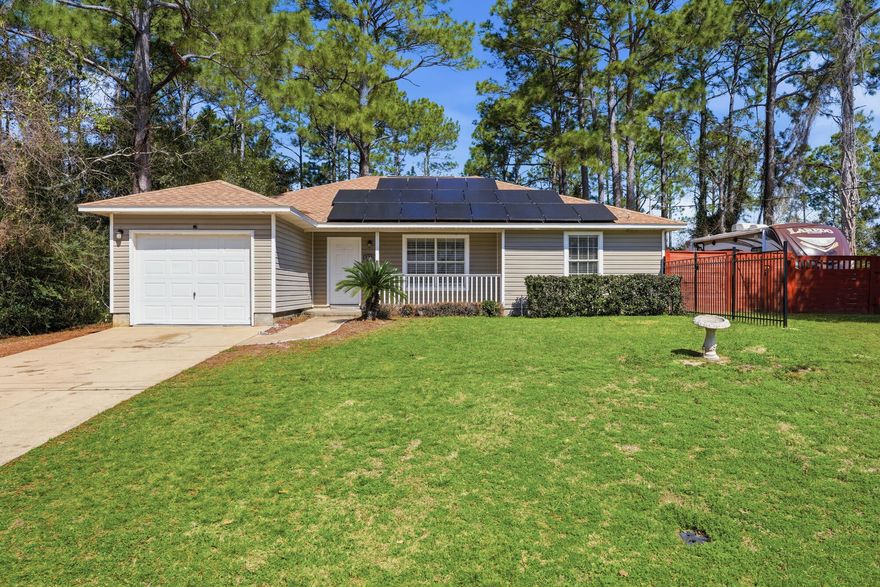 Move-in ready home with NO HOA on 0.65 acres in Navarre with paid-off solar panels. This 3BR/3BA split floor plan offers an open living, dining, and kitchen space with cathedral ceilings, flowing tile floors, and calming modern finishes. Enjoy granite countertops, stainless appliances, subway tile backsplash, and new vinyl flooring in the bedrooms. Arched doorways and bullnose corners add character throughout. Two bedrooms feature ensuite baths with granite vanities and all offer double closets. Relax or grill on the back deck overlooking a private, tree-lined lot that backs to a creek. Convenient to shopping, dining, beach and much more!