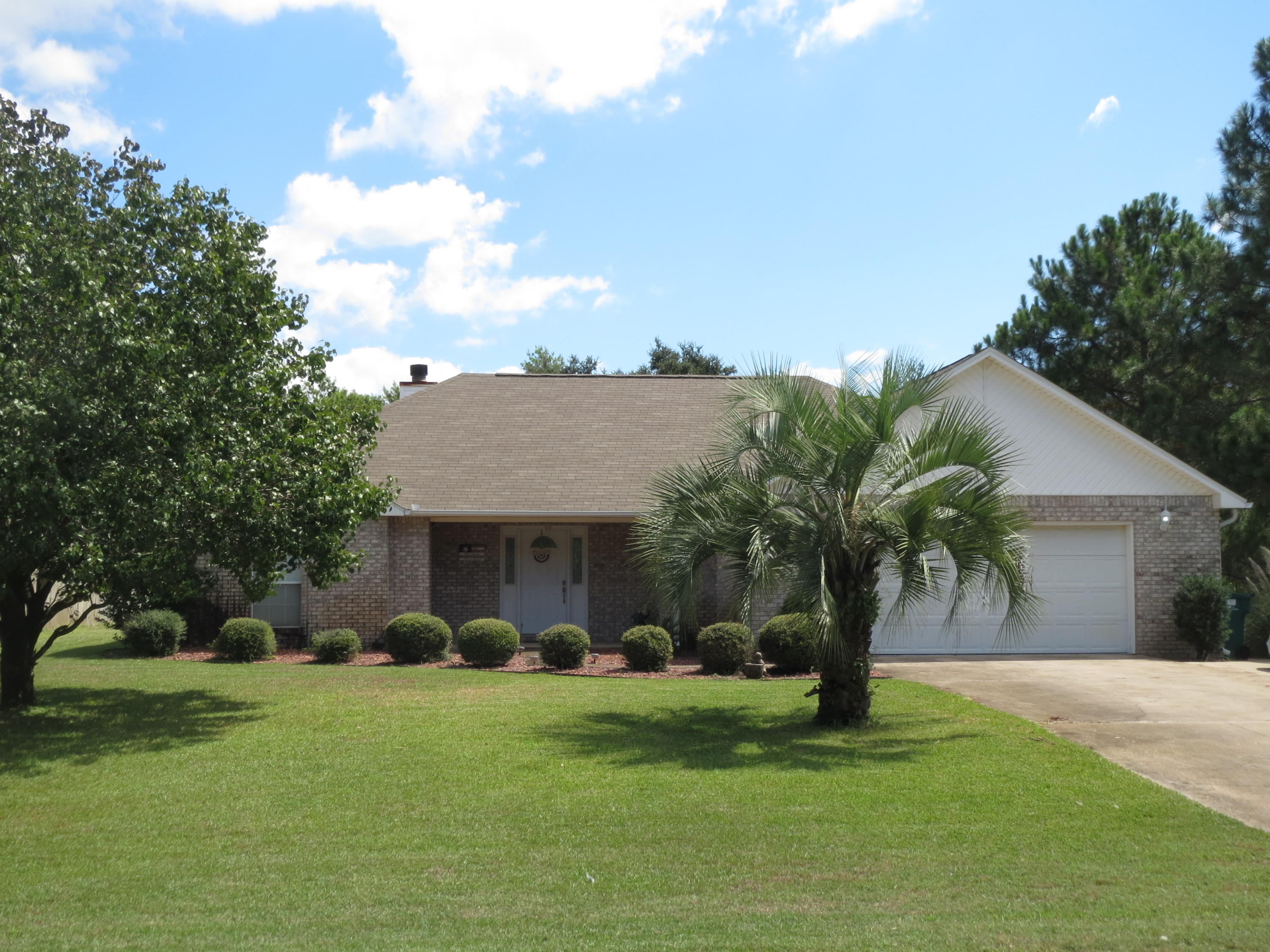 This meticulously maintained home in the desired Holley by the Sea neighborhood is sure to please with its spacious floorpan and cathedral ceilings. With many upgrades this home is not average it has a fully tiled master bath shower, corian countertops in the kitchen with a tile backsplash, wired for HDMI with a media closet and surround sound. A new energy efficient HVAC system was installed in 2014. Sprinkler system has a well and a new pump installed in 2013. The florida room gives you added space for either a playroom or a nice bright sitting room. The oversized garage has cabinetry and space for two cars plus lots of storage. Also there is an extra parking pad to give you more driveway space. Large backyard with a patio for entertaining and an 8x10 storage shed on a concrete slab.