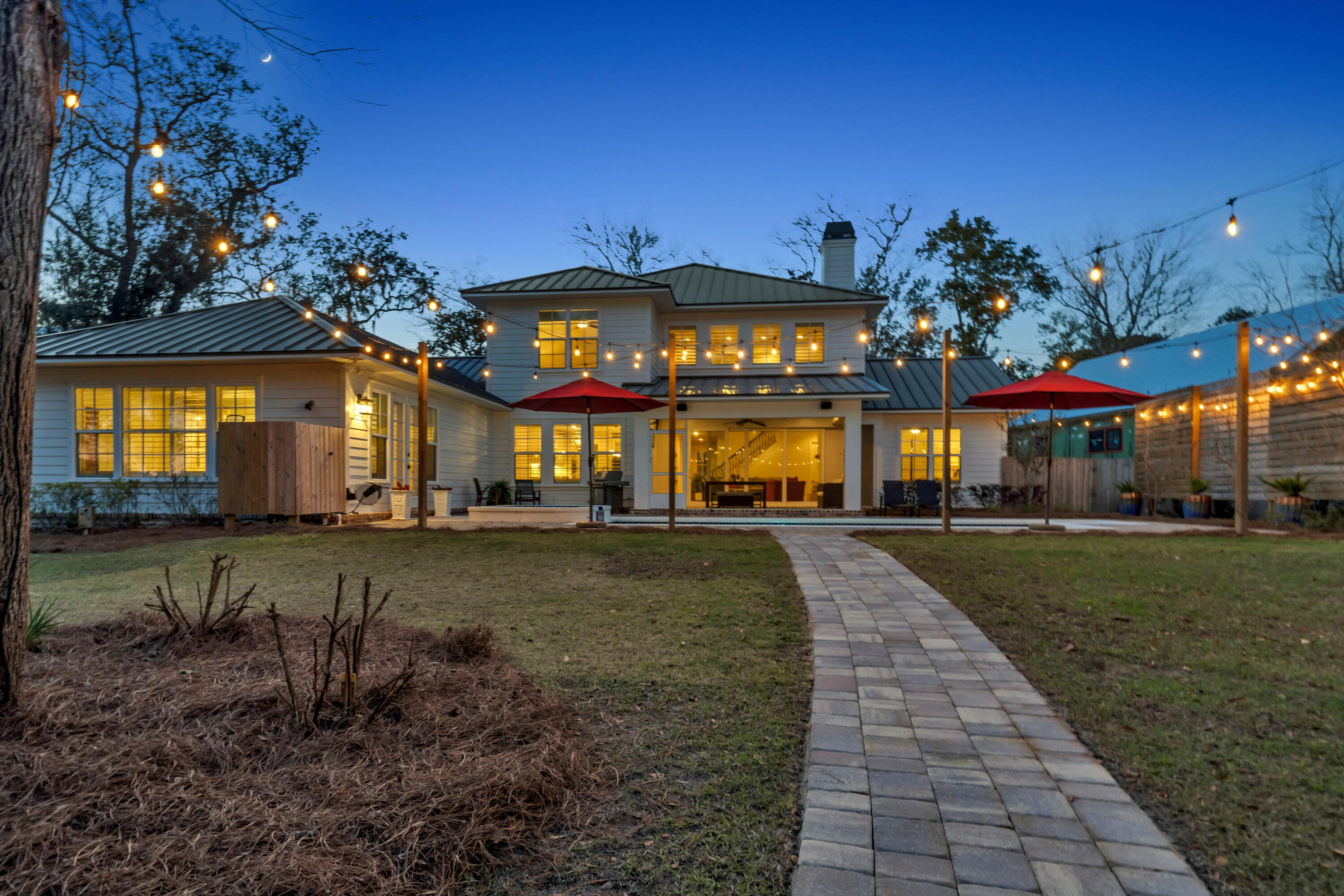 WELCOME HOME to your idyllic BOTANY BAYOU oasis. Located prominently on the bayou in secluded Botany Bayou. 474 Botany Boulevard offers the ultimate in exquisite coastal charm. A classic Southern facade welcomes you as you enter this grand residence. Step into an open floor plan with natural light cascading through multiple windows. A spacious living area looks out over the lanai and pool to the sparkling water of the bayou. Featuring soaring ceilings and a fireplace for those cool evenings, the living room flows to the chef's kitchen, breakfast area and butler's pantry. Step into the gourmet kitchen with refreshing views of the pool and hot tub and a large island, custom backsplash and high-end appliances. The primary bedroom is an oasis for relaxation; positioned for privacy