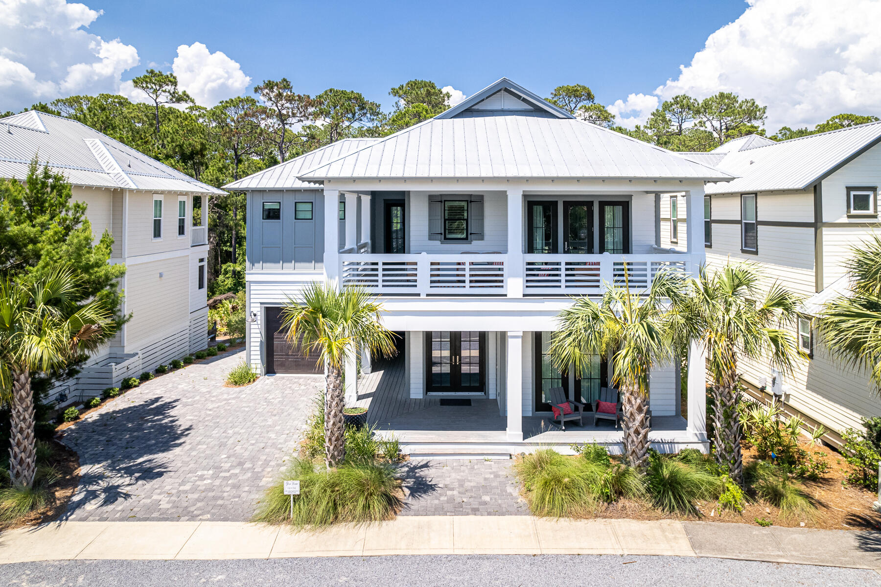 BACK ON THE MARKET! Beautifully constructed in 2020, this thoughtfully designed 4 BR/4.5 BA (plus bunkroom) home boast over 3000 square feet of well-planned living and entertaining space. No detail has been overlooked with standout finishes including wide plank floors, ship-lap accents, custom cabinetry, designer tile and lighting. The welcoming and open living room includes a coffered ceiling, large over-sized sofa, and a fireplace while the fully equipped kitchen offers commercial grade stainless appliances including a 6 burner gas range and extra-large island. Four large porches provide ample room to enjoy the warm Gulf breeze, and the two rear covered porches overlook the private wooded backyard with room for a pool. Additional highlights of this one-owner home include