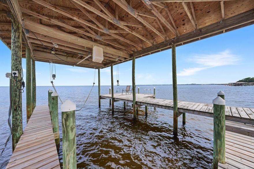 Beautiful setting on the Choctawhatchee Bay! Large private lot, driveway long enough for a boat trailer or RV, plus a large 2-car garage. Single story home boasts a vaulted ceiling in the living area and a tray ceiling in the Primary bedroom. The home has a split floor plan with guest bedrooms and primary separated by a large open kitchen, 2-bars, huge dining area and family room. Furnishings are optional.  All new led can lights throughout the home. 100 ft of aluminum seawall, rip rap, dock and boat lift. There is no HOA in this subdivision. No Fees! The only restrictions would be from Walton county on property usage. The subdivision is pretty much built out so the homes around this one are already built. There's also a great Landscaper that will gladly continue on with the new owner.