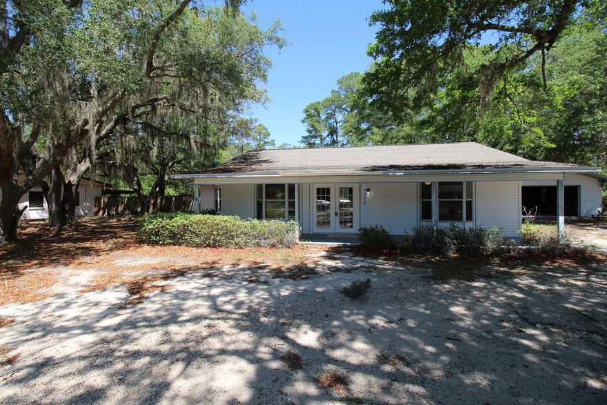 COMPLETELY REMODELED 2 BED 2 FULL BATH HOME READY TO MOVE IN!!! With Newer Roof (2yrs old), New 10yr Warranty AC, New Paint, New Stainless Steel Appliances, New Kitchen Cabinets, New Granite Countertops, New Tile Floors, New Carpeting, New Lighting & Fans, New Bathroom Vanities, Beautiful Wooded Fenced Yard, Screened Lanai for entertaining, Open Patio, Oversized Garage for the Toys & Workshop, Large Half Acre+ Corner Lot for Privacy  there is no honey do list, just move in and relax. This beautiful Move In Condition home is NOT a Short Sale or Bank Owned, just an exceptional home at a great price to sell quickly. This home is comfortable and spacious and includes an open floor plan. Don't hesitate on this exceptional opportunity!