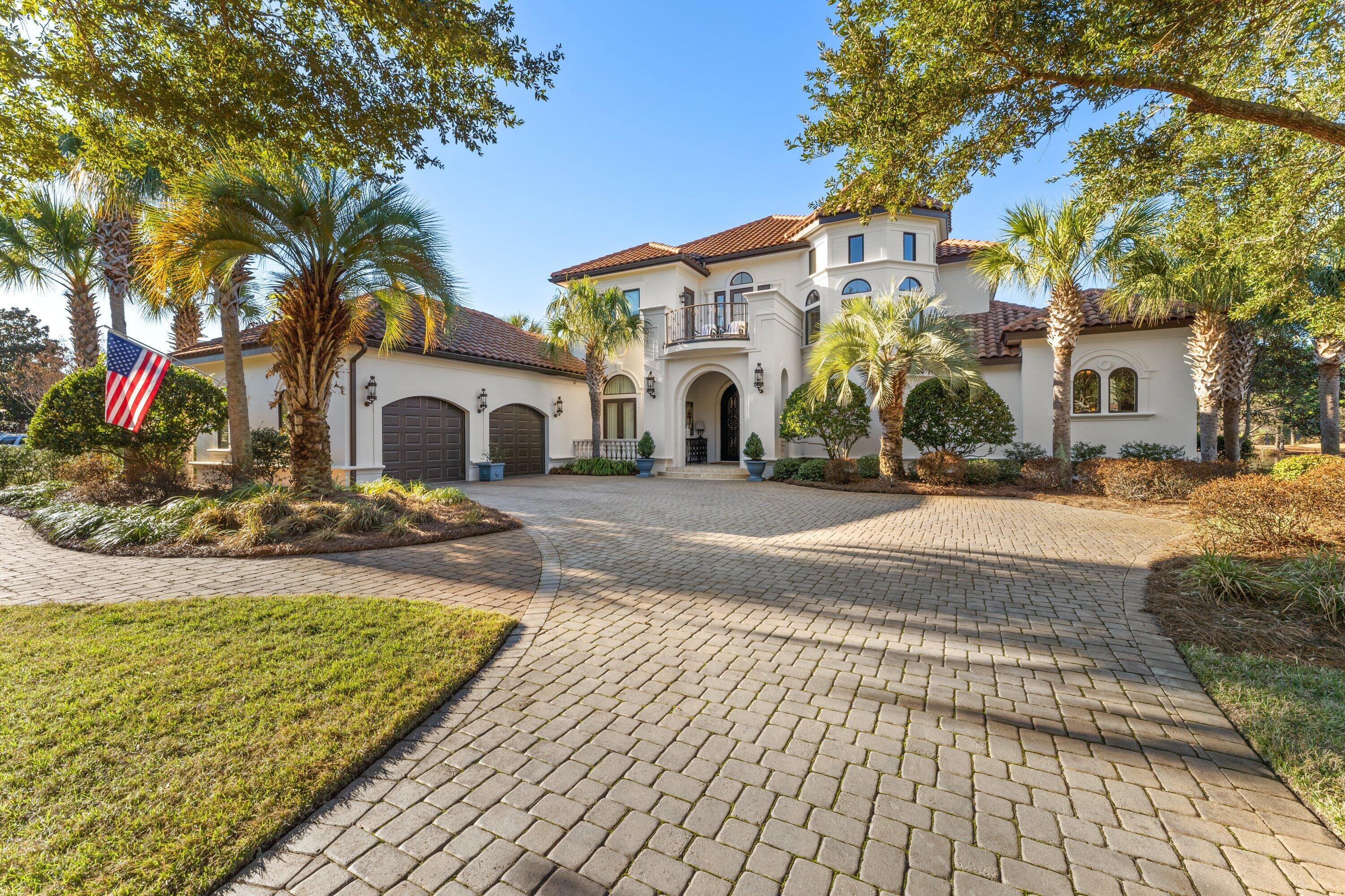 This Elegant Custom Estate Home features 4 spacious bedrooms and 5 baths. A warm and inviting 2 story foyer greets you with views of the salt water pool, lake, and golf course. The spectacular entrance is accented with soaring ceilings, formal living area, fireplace, and a wall of glass windows providing for tranquil pool and golf course views. The temperature controlled wine cellar is nestled beneath the curved, entry stairway. The gourmet kitchen features custom cabinetry, granite countertops, top of the line appliances, kitchen island, tile backsplash, recessed lighting, and spacious walk in pantry. This well designed floor plan conveniently situates the Master Suite on the main level, offering privacy, generous square footage. and easy access to the pool