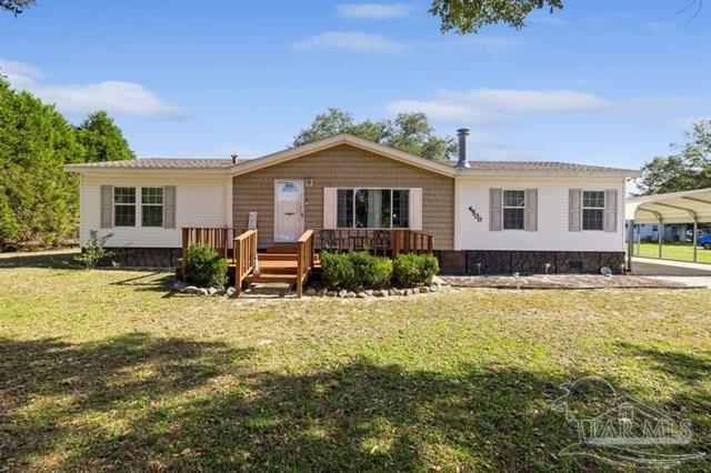 Welcome to the community of the peaceful Sleepy Hammock Farms in Milton, Florida. Situated just off US Highway 87 and south of I-10, this charming well-maintained home sits on over an acre of open, level, and cleared land,  plenty of space for small farm living. Built in 2005, the home features 3 bedrooms and 2 full baths across 1508 square feet, providing the perfect balance of comfort and convenience.The kitchen in this home is a standout, with lots of cabinets offering ample storage space, making it a dream for anyone who loves to cook. Adjacent to the kitchen, you'll find a separate dining area that's perfect for group meals or entertaining.  Additional features include wood-look flooring and a lovely home fireplace that enhances the warmth and charm of the home. Outside, you'll enjoy a fenced backyard, providing added privacy and a safe place for pets or small farm animals. The cleared yard gives you plenty of space for gardening, family activities, and even small farm animals, perfect for those looking for a mini farm. Imagine fresh eggs or a small goat or twothis property gives you the freedom to enjoy it all! There's also a full RV hookup, perfect for parking and connecting your RV when you're not on the road. For extra storage, the property includes several storage buildings, giving you plenty of space for tools, equipment, or hobbies.  Is there a sports enthusiast, bookworm, gamer or crafter in your life? Surprise! The separate country den provides a cozy retreat, perfect for sports watching, game nights, crafting or just relaxing. The property also boasts a covered carport and an open pole barn, ideal for storing an RV, boat, or extra vehicles. If you're seeking a home where southern comfort meets space to roam, 4500 Sleepy Hammock Road is ready to welcome you home!