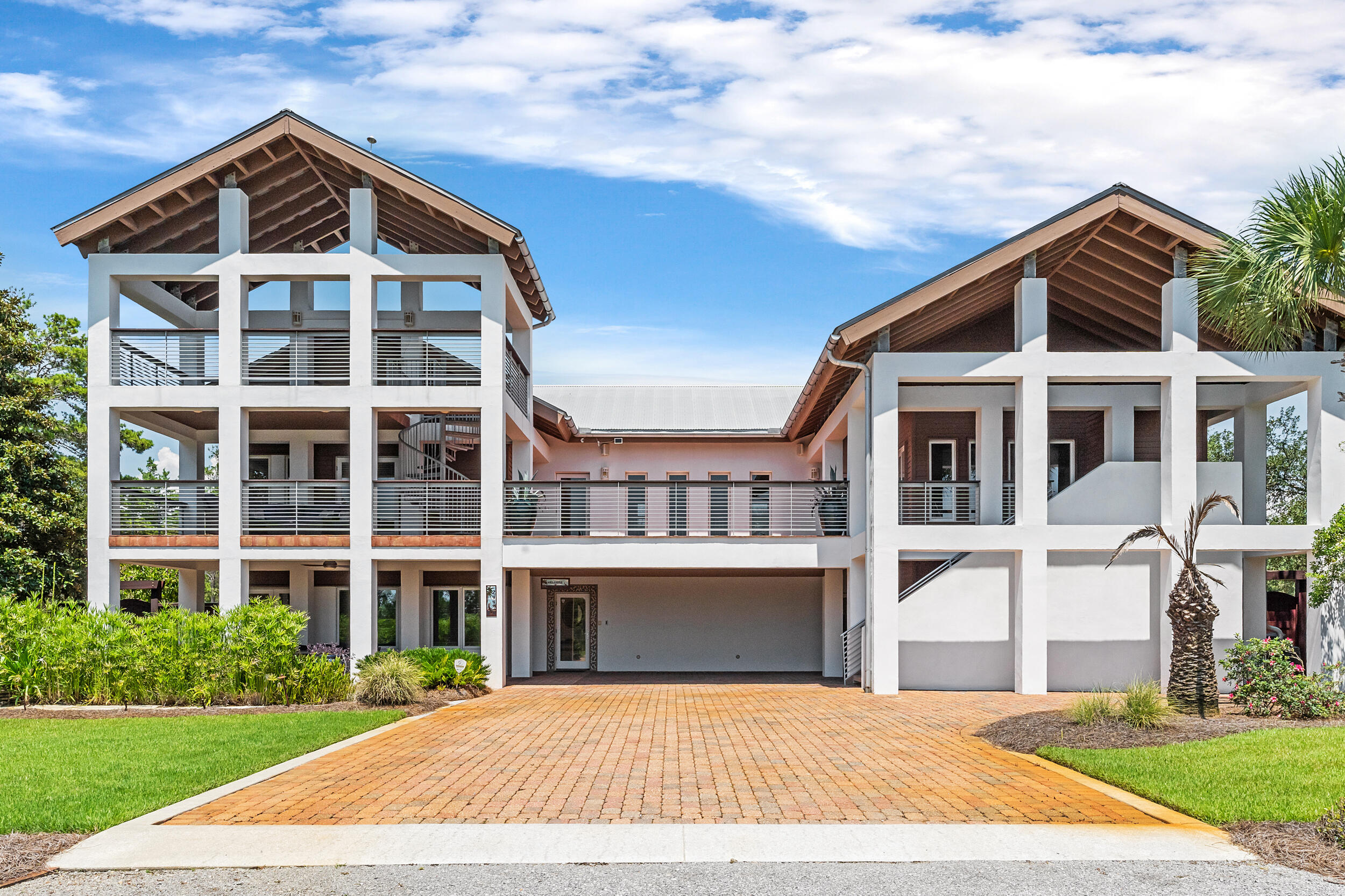 Welcome to your dream coastal retreat! This stunning custom-built home is situated on a spacious third-acre lot south of the west end of 30A, offering breathtaking Gulf views and an enviable location across the street from Topsail Preserve State Park. With nearly 4,000 sq. ft., this magnificent residence combines luxury, comfort, and exceptional craftsmanship. Dive into the large, sparkling, heated pool or host gatherings around the summer kitchen. Enjoy the warmth of an outdoor fireplace in the Fall and Winter. The landscaped yard also features a serene koi pond, creating a perfect ambiance for outdoor enjoyment. The oversized balcony and additional ''crows nest'' provide panoramic Gulf views, making it an ideal spot to watch the sunset. Just a golf cart or bike ride away to the beach.