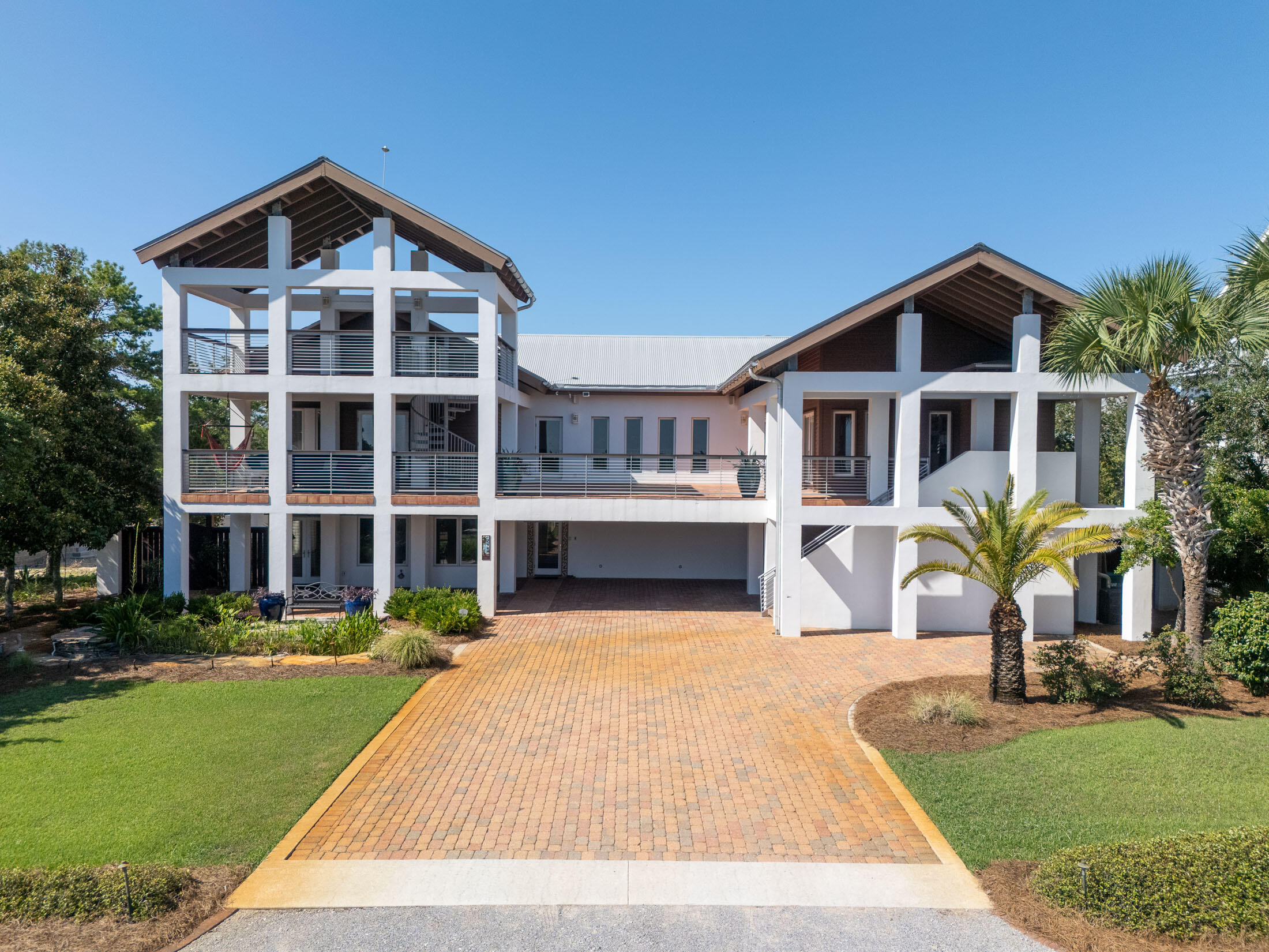 Welcome to your dream coastal retreat! This stunning custom-built home is situated on a spacious third-acre lot south of the west end of 30A, offering breathtaking Gulf views and an enviable location across the street from Topsail Preserve State Park. With nearly 4,000 sq. ft., this magnificent residence combines luxury, comfort, and exceptional craftsmanship. Dive into the large, sparkling, heated pool or host gatherings around the summer kitchen. Enjoy the warmth of an outdoor fireplace in the Fall and Winter. The landscaped yard also features a serene koi pond, creating a perfect ambiance for outdoor enjoyment. The oversized balcony and additional ''crows nest'' provide panoramic Gulf views, making it an ideal spot to watch the sunset. Just a golf cart or bike ride away to the beach.