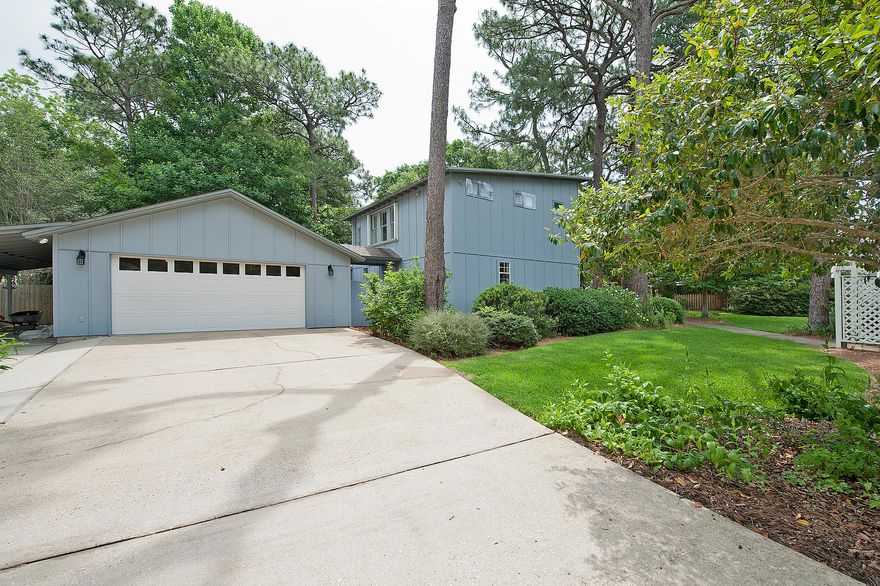 A distinctive flair is what you will find in this generously-sized two-story home near the point of Tom's Bayou. Step right in through the welcoming French doors which will charm all who cross the threshold. The foyer leads you to a really roomy open living area, which keeps the cook engaged. From snacks to supper, everyday meals do not have to be formal when using this spacious breakfast bar which could easily hold 4 bar stools. Main-level laundry and guest bathroom are conveniently located in this open area. The formal dining room boasts a built-in cabinet which could highlight your china. This room also has a wood burning (propane gas connection available) fireplace. Looking for a room with lots of natural lighting? (Click more)