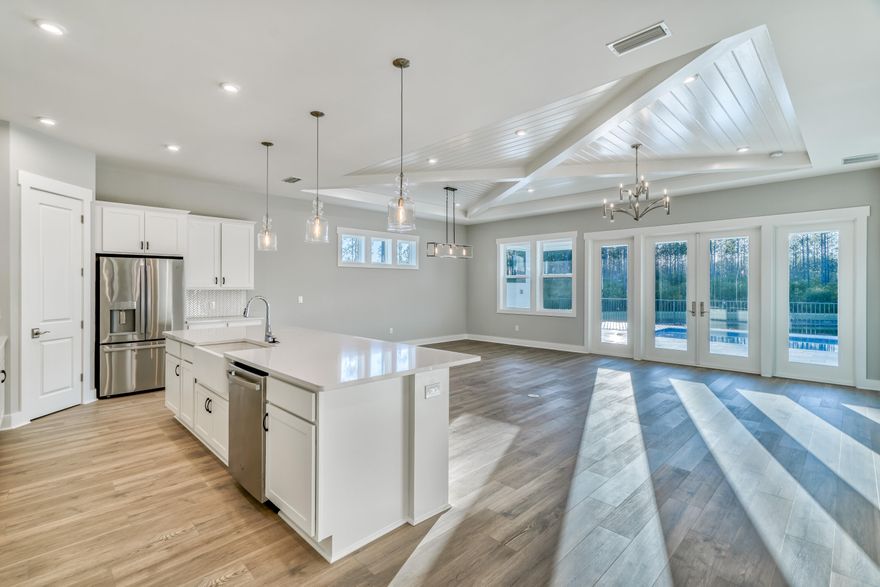 Brand new home in the Private & Gated NatureWalk at Watersound Origins community. Home is loaded with upgrades including, Private heated salt water pool on a premium corner lot that backs up to a beautiful lake overlooking the state forest. This stunning 1 level home has an upgraded entryway with V-Groove walls, 3 bedrooms, plus a large den / office that could function as a 4th bedroom and the Master has incredible views of the pool, lake and nature preserve. Additional features include: upgraded shell stone pavers around pool and lanai, 2 car garage, upgraded Mohawk Revwood floors throughout, upgraded designer Kitchen with 18'' upper cabinets to the ceiling, V-Groove on island, trash pullout, pot & pan drawer under cooktop - true gourmet kitchen. (see more) GE stainless appliances, Farmhouse sink, upgraded painted cabinets with soft close drawers & doors in the kitchen and bath, silestone quartz countertop in kitchen & baths, 36"natural gas cooktop with griddle, decorative wood Ceiling beams in the great room with V-Groove ceiling, freestanding tub and shower in master, privacy wall on rear lanai porch with gas stub, rain head and handheld sprayer upgrades in master shower, Rinnai tankless hot water heater ,LED lights throughout and dedicated 20 amp & 30 amp outlets in garage - great for a golf cart. Home comes with a termite warranty from Home Team Pest Defense and also includes the Taexx Built In Pest Control System from Home Team Defense. Home has a large fenced in back yard.