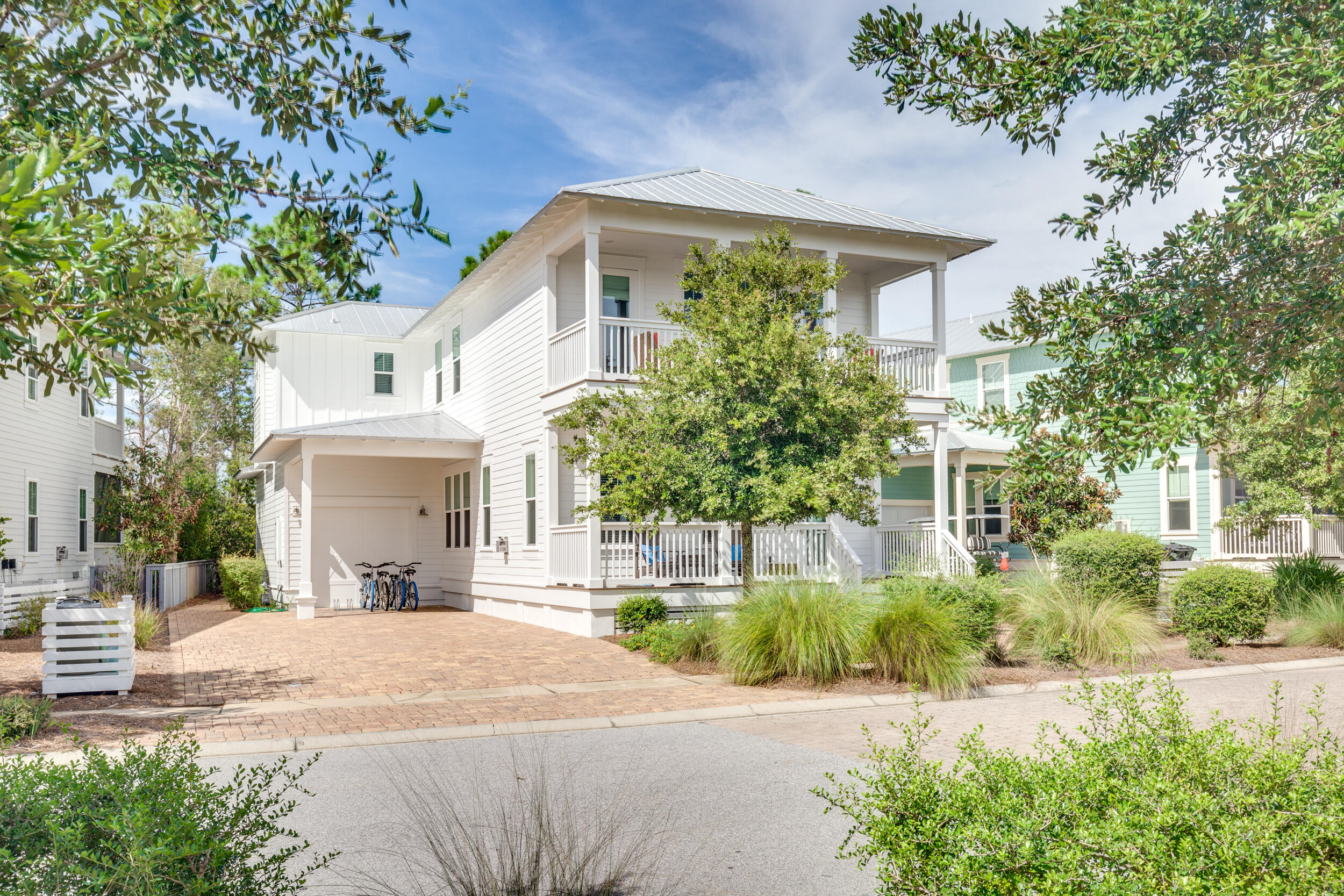 Welcome to the Emerald Jewel, this very well cared for cottage is located in a prime location, just 3 houses down from the community pool and steps to the path to the beach! Since January 2021 this home has done $124k in rental income. CDD Bond is paid off= lower taxes. This pie shaped lot allows for lots of parking in the driveway and also carport and extended garage. This cozy beach cottage welcomes & calms you as soon as you walk in the front door with neutral colors and impeccable finishes. Living room offers a gas fireplace with shellstone tile surround and white beams with crown moulding. There's plenty of room to relax with your loved ones.