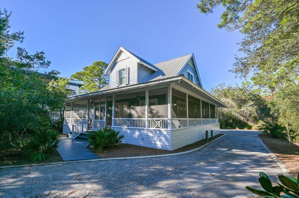 Situated at the end of a long private driveway, this capacious family home in Lake Place has the benefit of a recently added carriage house and two-car garage. Fully renovated, this traditional home is suitable for a primary residence or second home with ample space for guests and entertaining. Indoor and outdoor living spaces are balanced with a bright open family room and wraparound porch of the home. It's a place for relaxing on the swing seat and watching the world go by through screened vegetation. The full-width porch provides access to the home through three sets of French doors. They open into a light-filled double-height foyer. Polished wood flooring leads the way through a series of living areas for relaxing, dining and watching TV