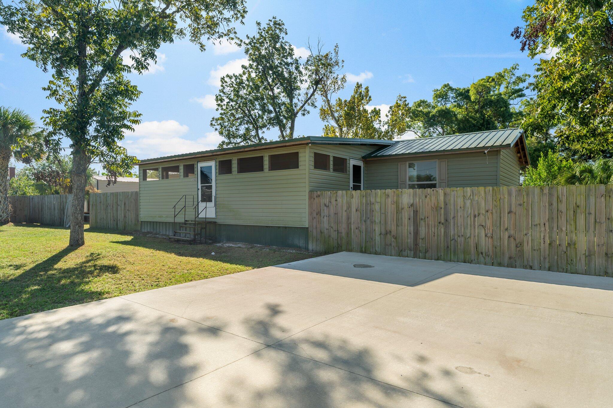 Welcome to your new home, conveniently located convenient to Tyndall Air Force Base! This charming 2017 manufactured home offers the perfect blend ofcomfort and convenience. With 2 spacious bedrooms and 2 bathrooms, you'll have plenty of space to relax and unwind. As you step inside, you'll immediatelynotice the open-concept living and kitchen area, creating a warm and inviting atmosphere for everyday living and entertaining. Imagine sipping your morningcoffee or enjoying a cool evening breeze on the front screened-in porch/sitting area, adding an extra layer of relaxation to your daily routine. For those who loveoutdoor activities and storage space, the back door opens to a covered patio area, ideal for additional parking or creating an outdoor oasis. There's also agenerous 20x