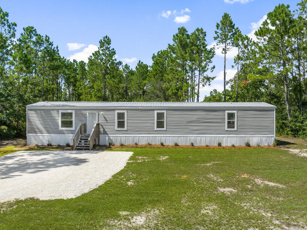 Your Coastal Getaway Awaits! Located in the heart of Santa Rosa Beach, this 3 bedroom, 2 bath home offers the perfect blend of privacy and convenience. Just minutes from the best of 30A and South Walton, you'll enjoy easy access to both the beach and the bay. Sitting on a spacious .55-acre lot with no HOA, this 1,140 sq ft 2019-built mobile home has everything you need--whether you're looking for a personal retreat or a rental opportunity. Inside, you'll find an open concept living room and kitchen, split floor plan, and a built-in entertainment center. The kitchen features stainless steel appliances, a farm sink, breakfast bar, and recessed lighting. The oversized main shower adds a touch of luxury to your daily routine. Outside, enjoy a fenced area behind the home, plenty of room for vehicles, boats, or water toys, and the convenience of public road access, water, and sewer. No HOA. Just freedom and coastal living at its best. Schedule your showing today!
