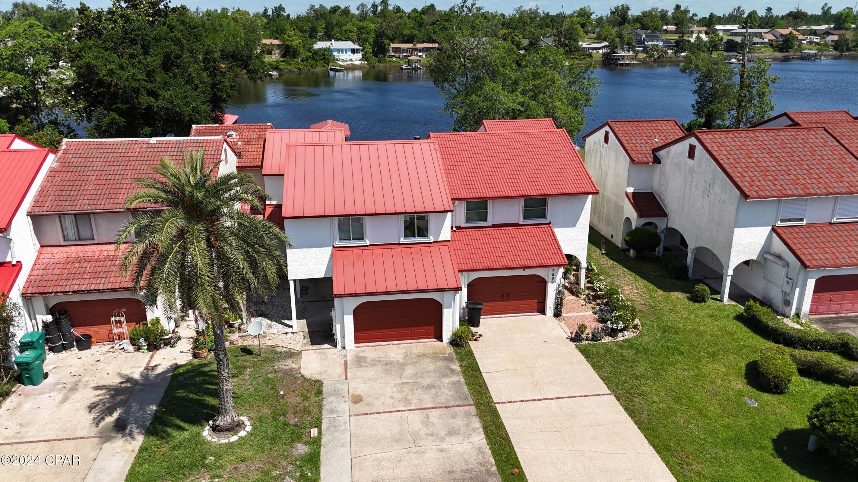 WATERFRONT townhouse on Callaway bayou with gulf access. This property features a bock dock with covered lift. Just painted light grey inside and white stucco out. Standing seam metal roof was replaced 5 years ago. New windows and slider door just installed, protected by built in hurricane shutters. All three bathrooms have been updated with LVP floors, teak vanities, and granite countertops. The kitchen has new cabinets, counters, appliances, with backsplash being installed. The garage provides abundant storage not seen on most townhouses. Located on Callaway Bayou just over a mile from the open bay and about 30 mins to the Gulf.  House is covered with termite bond.  NO HOA fees.