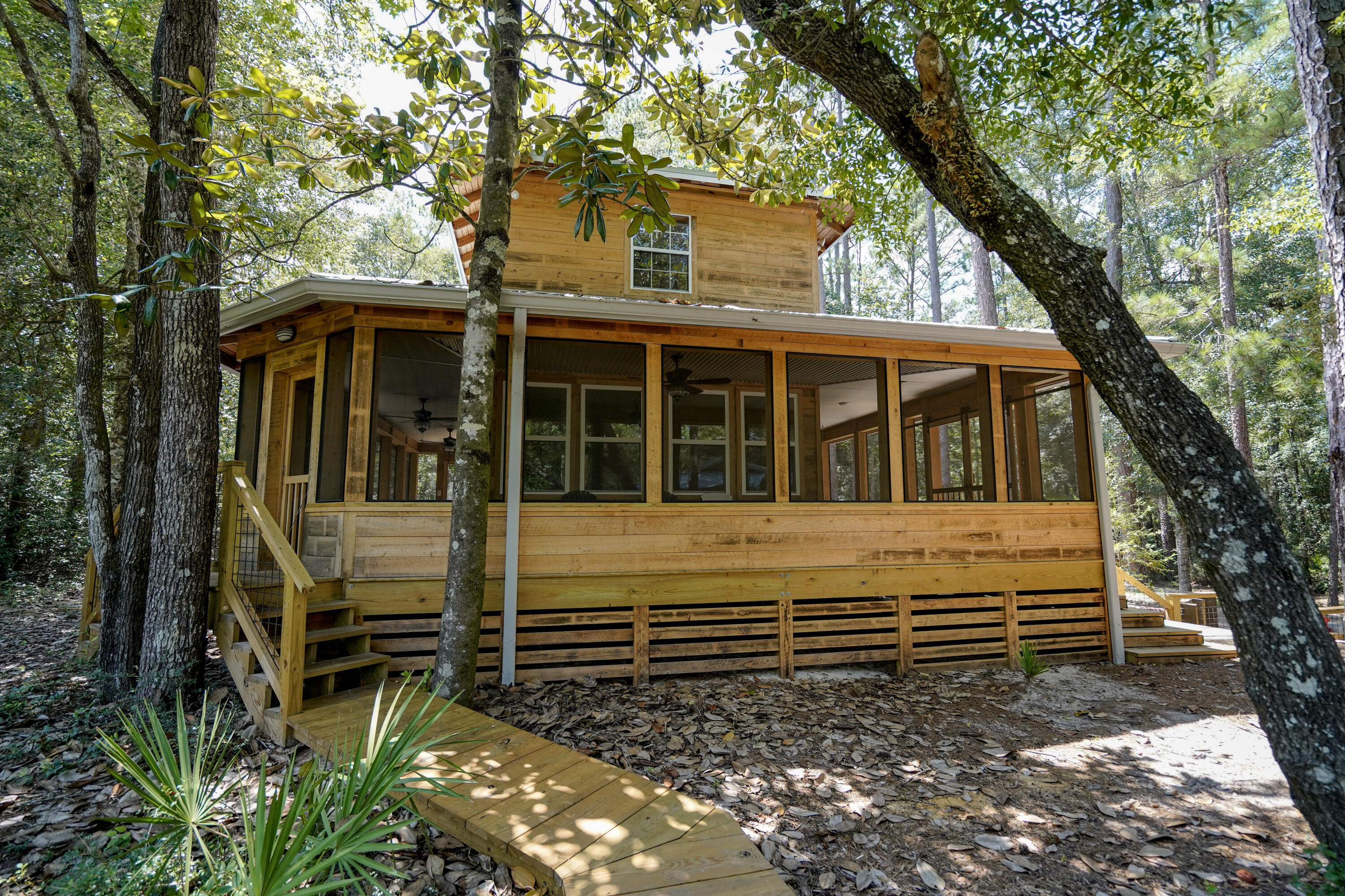 Two lots being sold together. This is a completely off the grid river camp or hunting lodge with a boat launch and a covered picnic area. It has solar panels and a whole house. generator as well as two mini splits and the water source is an artesian spring fed well. It has a creek running through the front part of the property and it sits directly on the Shoal River with a bluff across the river so it is very secluded. It has a rain shower outside, a dock, it has a complete kitchen with all new mini appliances, it even has a washer and dryer inside. Wrap around screened in porch complete with a porch swing. Includes a polar cowboy plunge pool and covered mini pole barn. This is a unique one of a kind get away property yet close to town. 15 minutes from grocery stores and restaurants. Lots of wildlife - this area is rich in local history. It is the perfect getaway with potential for short term rentals. It has foam insulation blown in and two sleeping areas upstairs with beautiful views of the river. It has never been rented, or used, so everything is brand new. Hand burnished cypress exterior. The buildout was a. labor of love.