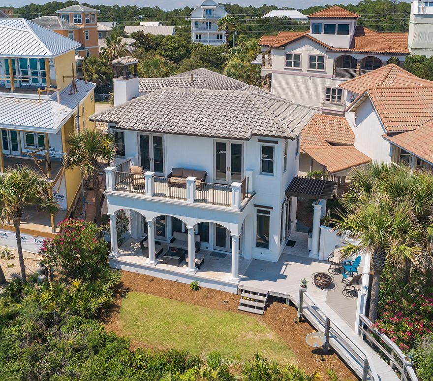 Breathtaking views of the gulf, a private beach walkover and more than 50 feet of waterfront are hallmarks of this exquisite 4 bedroom, 4 bath gulf-front Mediterranean-styled home located in the heart of Seagrove. Large updated light and bright kitchen is a chef's dream featuring Viking appliances, granite counters, wine chiller and designer cabinets. The open concept living, dining and kitchen areas make this gulf front home ideal for entertaining. Main living area w/ stacked stone fireplace on first floor has sweeping views of the gulf, a large outdoor covered patio, expanded deck with outdoor grill, private walkover to the beach and a great gathering green space for family games or a private pool. First floor features bunk room with adjacent full bath.