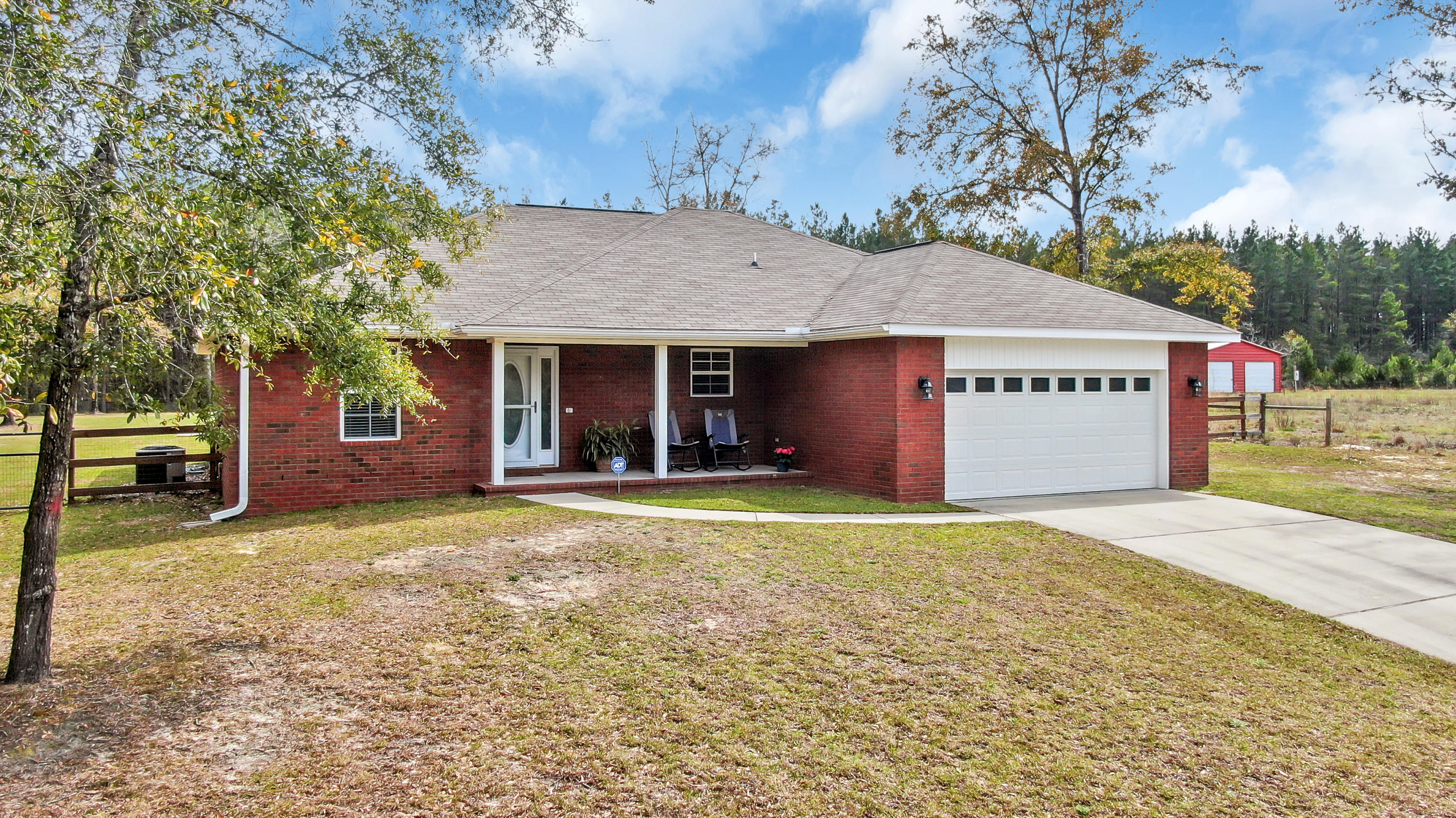Like new, this all brick home is just what you've been hoping and praying would come on the market! With just under 1600sf and on nearly 1 acre, this 3 bedroom 2 bath/2 car gar, open concept, split floor plan has ALL the extras...! The kitchen features custom cabinets, granite, stainless appliances, pantry, & is open to the dining area & family room. The master suite is quite spacious, with large walk-in closet & raised double vanity with walk-in shower. The piece de resistance is the glorious 15x41 back porch (615sf!) with cathedral ceiling. This overlooks your peaceful fenced back yard, which include a fire pit for fun family & friends time. Also included is a heated & cooled outbuilding; perfect for an office, storage or craft/play room. Don't delay seeing this stellar new listing!