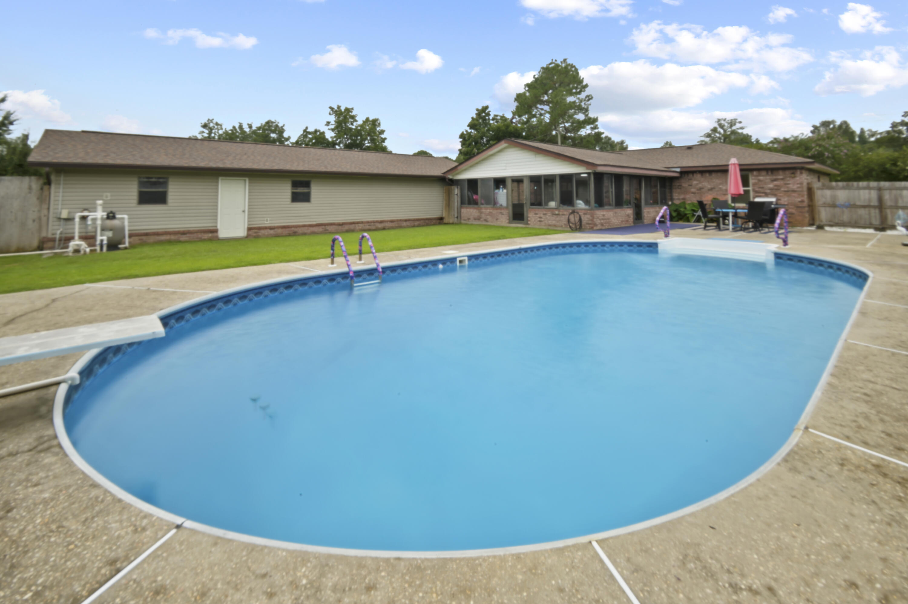 POOL HOME - you NEED to see this UPDATED home, it has EVERYTHING! Sitting on nearly AN ACRE of land, this property not only offers a massive in-ground pool but also a 1350 SQFT detached WORKSHOP/GARAGE, a 600 SQFT SUNROOM, FIBER OPTIC INTERNET, and a FLEX ROOM for an OFFICE! Stepping inside, you are greeted by a spacious living room complete with pool views and a vaulted ceiling. The kitchen is designed for the family chef with stainless steel appliances, a massive pantry, seemingly unlimited counter space, and tons of storage. The master bedroom is huge, easily accommodating a king bed while still offering ample room for additional furniture without feeling crowded. The master has both a deep walk-in closet and an updated en-suite bathroom - complete with a dual vanity. The additional 2 bedrooms are perfect for guests or kids, with space for a queen bed set and sharing a bathroom in the hallway. The updated laundry room is huge and doubles as extra room for storage. Stepping out back, marvel at the 600 sqft sunroom with an abundance of natural light provided by the wrap around windows. This space provides the optimal space to enjoy the outdoors without Florida's famous bugs pestering you! Between the pool and the sunroom is a large patio that is set up for grilling, and on the other side of the pool is a large lawn for the pets! The size of the detached workshop/garage cannot be captured in photos. At 1350sqft, this is the perfect space to store all your toys and tools, while still having space to complete any projects you have in mind. Don't let the privacy fenced yard fool you, the lot extends back an extra .4 acres that are cleared behind the fence line, with both tangerine trees and lemon trees. THIS HOME HAS IT ALL! Stop on by and snatch it before anyone else does! New septic system (2022), Roof (2019), water heater (2024), kitchen appliances (2021), washer/dryer (2021), and pool liner (2022).