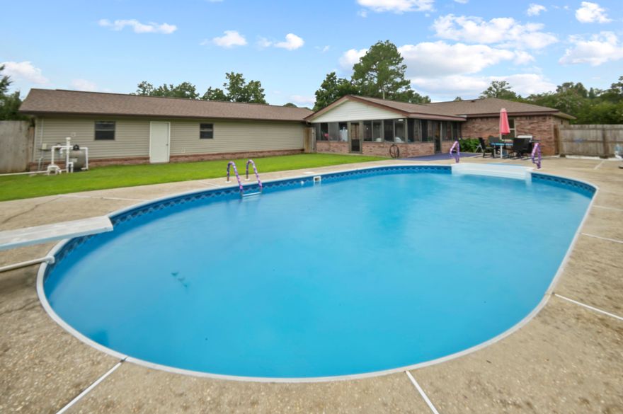 POOL HOME - you NEED to see this UPDATED home, it has EVERYTHING! Sitting on nearly AN ACRE of land, this property not only offers a massive in-ground pool but also a 1350 SQFT detached WORKSHOP/GARAGE, a 600 SQFT SUNROOM, FIBER OPTIC INTERNET, and a FLEX ROOM for an OFFICE! Stepping inside, you are greeted by a spacious living room complete with pool views and a vaulted ceiling. The kitchen is designed for the family chef with stainless steel appliances, a massive pantry, seemingly unlimited counter space, and tons of storage. The master bedroom is huge, easily accommodating a king bed while still offering ample room for additional furniture without feeling crowded. The master has both a deep walk-in closet and an updated en-suite bathroom - complete with a dual vanity. The additional 2 bedrooms are perfect for guests or kids, with space for a queen bed set and sharing a bathroom in the hallway. The updated laundry room is huge and doubles as extra room for storage. Stepping out back, marvel at the 600 sqft sunroom with an abundance of natural light provided by the wrap around windows. This space provides the optimal space to enjoy the outdoors without Florida's famous bugs pestering you! Between the pool and the sunroom is a large patio that is set up for grilling, and on the other side of the pool is a large lawn for the pets! The size of the detached workshop/garage cannot be captured in photos. At 1350sqft, this is the perfect space to store all your toys and tools, while still having space to complete any projects you have in mind. Don't let the privacy fenced yard fool you, the lot extends back an extra .4 acres that are cleared behind the fence line, with both tangerine trees and lemon trees. THIS HOME HAS IT ALL! Stop on by and snatch it before anyone else does! New septic system (2022), Roof (2019), water heater (2024), kitchen appliances (2021), washer/dryer (2021), and pool liner (2022).