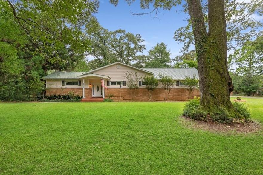 Mid-century modern beauty on 1.38 acres in! Massive 3966 square feet brick home with over an acre of land. This home has 4 bedrooms and 3 baths, 2 of which have ensuites and an office. The master suite shares a huge cedar lined walk in closet and a bathroom with a dual head tiled shower and a corner jacuzzi tub. The kitchen has numerous updates to include soft close cabinets and drawers, granite counters  with breakfast bar and stainless steel appliances. The home offers both a dining area and dining room. The great room has vaulted ceilings with exposed beams and an amazing wood burning fireplace. But the feature that will stand out to you the most when you walk in this mid-century modern beauty is the expansive windows that lead to the massive covered back porch and