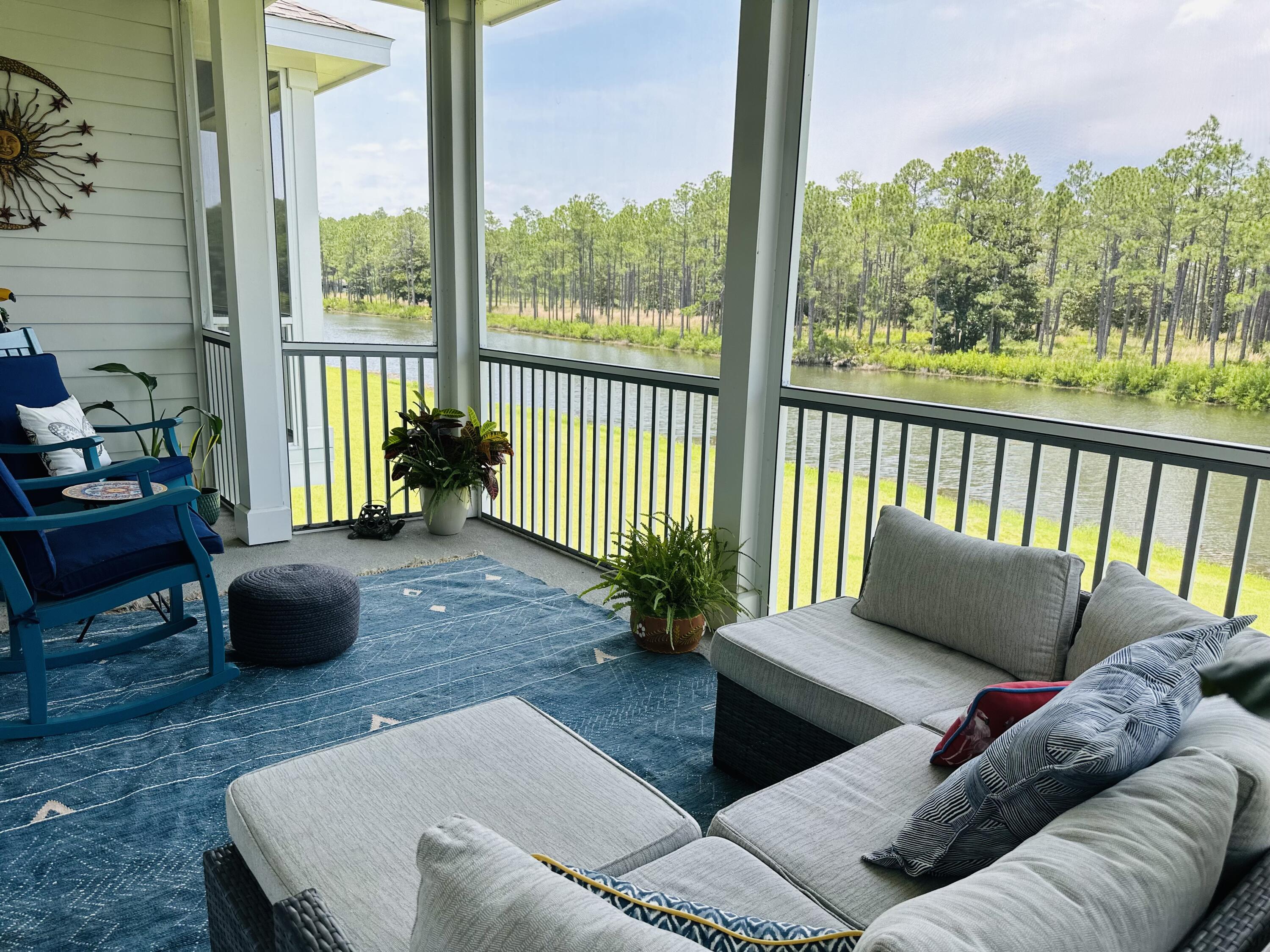 Beautiful lakefront townhome with exceptional views inside and out. Less than 3 miles from the beach and the bay. Designed with comfort and sophistication in mind, the interior features high ceilings, and an open, light-filled layout. The gourmet kitchen is a chef's delight, boasting custom soft-close cabinetry, quartz countertops, stainless steel appliances, a gas cooktop, and an oversized island ideal for entertaining.