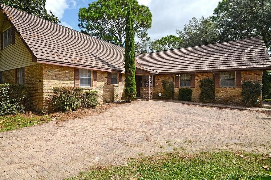 Don't miss this newly remodeled classic home in the heart of Fort Walton Beach! This classic brick circular drive welcomes visitors to this sunny corner lot convenient to everything! Just minutes to beaches, shopping, and bases. Inside on the main level, discover 3 bedrooms & 2 full baths, an open & functional living space, two dining areas, a spacious kitchen overlooking a serene private garden, & an enviable sunroom featuring floor-to-ceiling glass enclosures & brick pillars. Original hardwood floors grace the stairway & continue throughout the second floor with the two large bedrooms & a full bath. The fully-fenced backyard is an oasis with mature shade trees & hardscaping that make both entertaining & lounging easy & private.