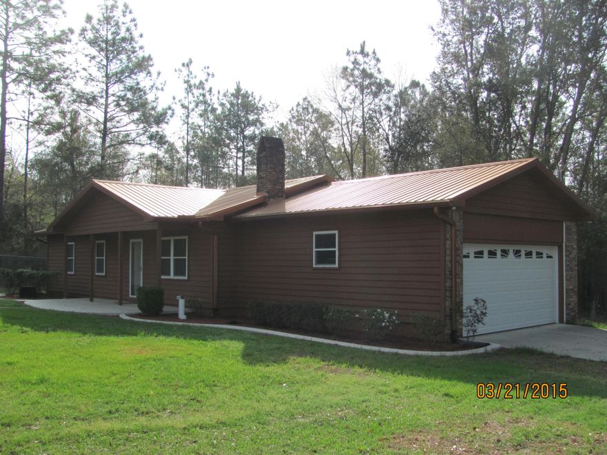 PRICE REDUCED & LAKE FRONT!!! Home with workshop and RV carport on 2.08 acres with 528 feet of LAKE FRONTAGE!!! Enter home into foyer that leads to living room with 42 fireplace with cedar mantle and heatilator. Dining room has sliding glass doors that lead to a raised, open deck with lake view. Kitchen has been remodeled with granite counter tops. All kitchen appliances convey including trash compactor. Floors are tile in kitchen and dining area and master bath, carpet in bedrooms. New deep, stainless steel sink with delta faucet installed in 2013. All bedrooms are on one side of the home. This is a 3 bedroom/2 bath, 1,215 sq foot, home. Master bath has a full bath (tub/shower)