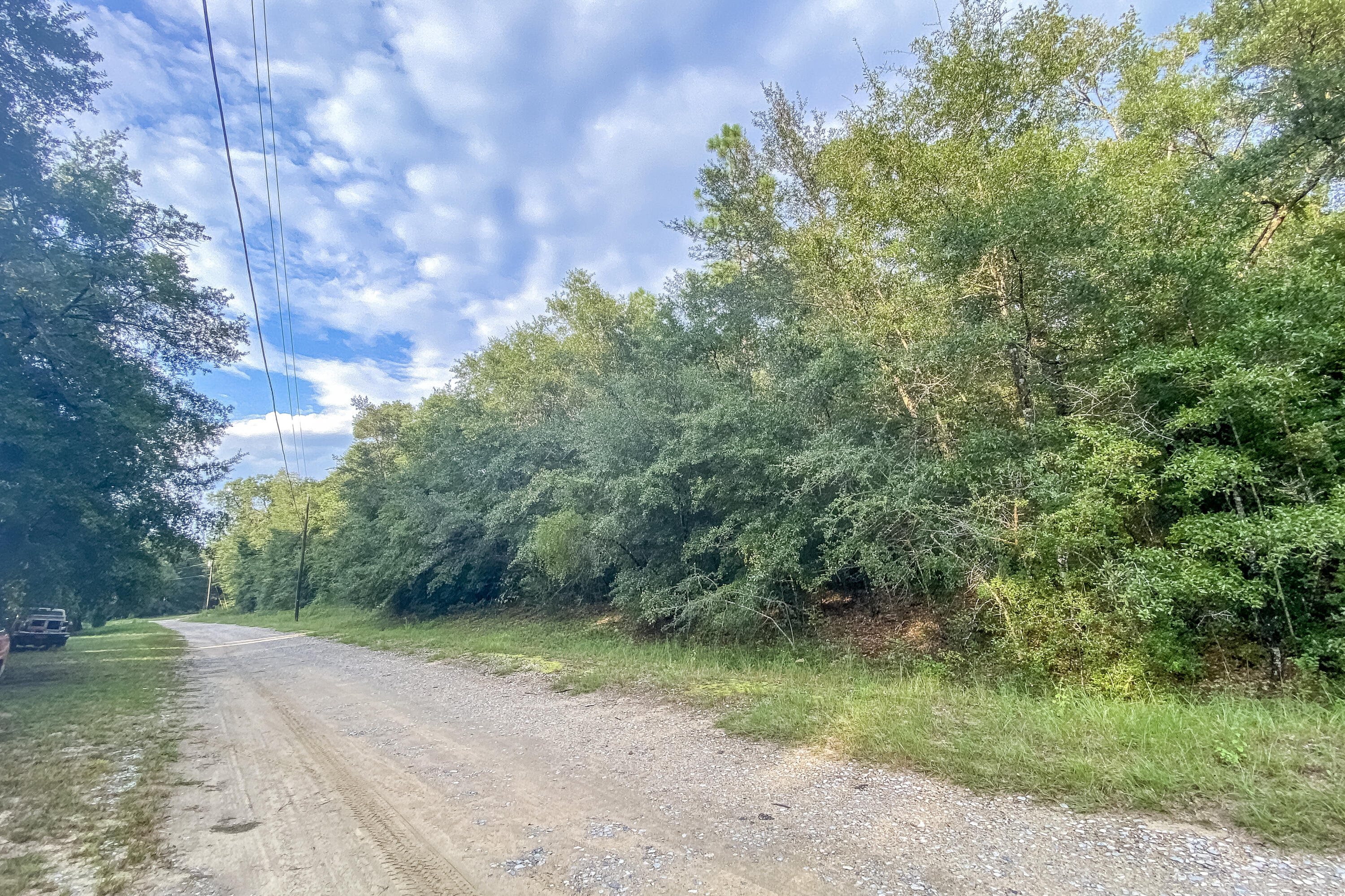 Vacant wooded lot Approx 1 acre in size. It is high and dry. Build your new home or place a mobile home. Located in North Crestview just minutes from downtown on a no through traffic street, and 'No HOA fees.The subdivision has a common area for 'residents only' and provides private river access to enjoy great outdoor activities like fishing and kayaking. There are no utilities in place.Flood. zone: X (No flood zone).Access: Dirt Road - Private Road.Power: Available in the area.Water: Would be by Private Well.Sewer: Would be by Septic.Zoned: RESIDENTIAL RURAL (RR) Mobile homes allowed.