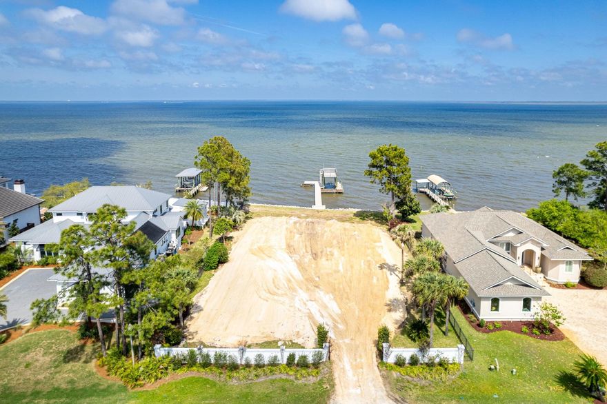 Rare and exceptional opportunity to build a spacious retreat perched on the banks of stunning Choctawhatchee Bay. Custom plans available, seawall, and dock in place. Lot graded and ready to build! Take a Sunday Drive down Driftwood Pt. Road where all eyes lead to the water. Escape to a private Oasis with 100' of bay frontage ad endless sunrises. Minutes from the Emerald Coast's finest beaches, shopping, dining and entertainment yet world's away from everyday distractions. Boating is easily accessible with the recently reconstructed covered decking with deck featuring flow through docking. Lot improvements include seawall, front entry fencing, and refurbished dock. Low HOA costs, friendly neighbors, and pink hued sunsets. Discover life on the bay!