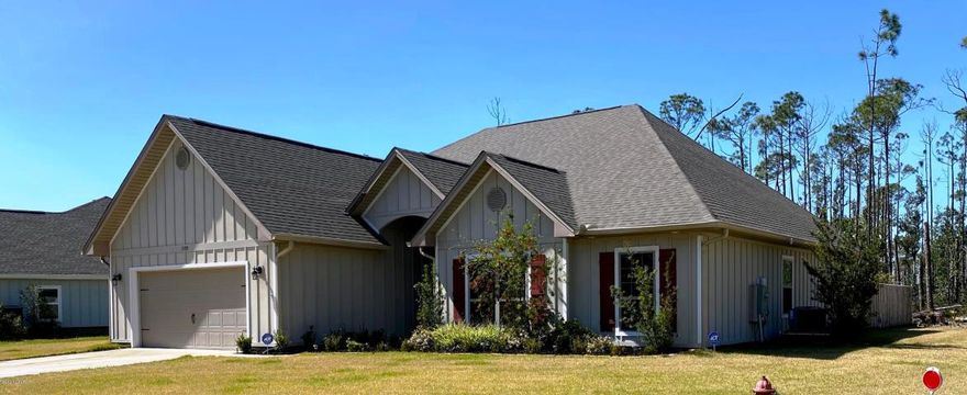 Beautiful craftsman home in the sought after gated waterfront community of Laird Point near Tyndall Air Force Base. This well thought out 4 bedroom floor plan offers plenty of space for your families enjoyment. Finishes include raised trey ceilings, beautiful hardwood floors in the common areas, new carpet to be installed in all bedrooms, tile in kitchen and baths with granite counter tops throughout the home. The kitchen is open to the breakfast area with beautiful custom cabinets, granite counter tops, tile back splash, stainless appliances, a pantry and opens to a formal dining room. The large great room boasts, hard wood floors, beautifully trimmed trey ceilings and archways that lead to the Florida room.