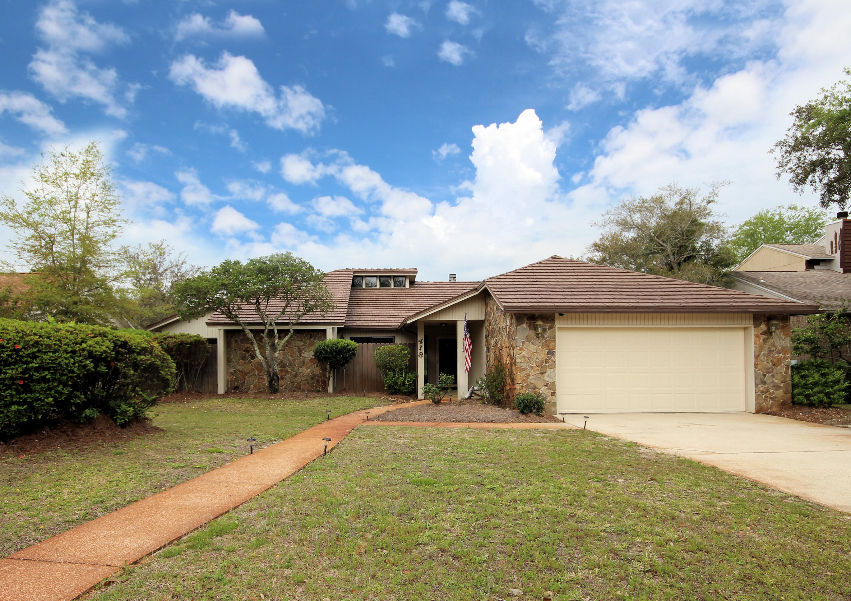 This stunning Florida contemporary has it all! Upgrades grace the eat-in kitchen with granite countertops, stainless appliances, and updated fixtures. Spacious master suite has walk-in closet, screened porch with water view, large master bath with double vanity, sunken jetted tub, and walk-in shower. Additional bedrooms have walk-in closets and walk-out patios! Gas fireplace is the focal point of the living and dining room. Skylights and vaulted ceilings make this home light and bright, while the Florida room overlooks the backyard and lake. Numerous upgrades: laminate and tile flooring, new paint, newly textured ceilings, new A/C and tankless gas hot water heater 2013, metal roof, security system, aluminum fence, outdoor shed and gas grill connection.